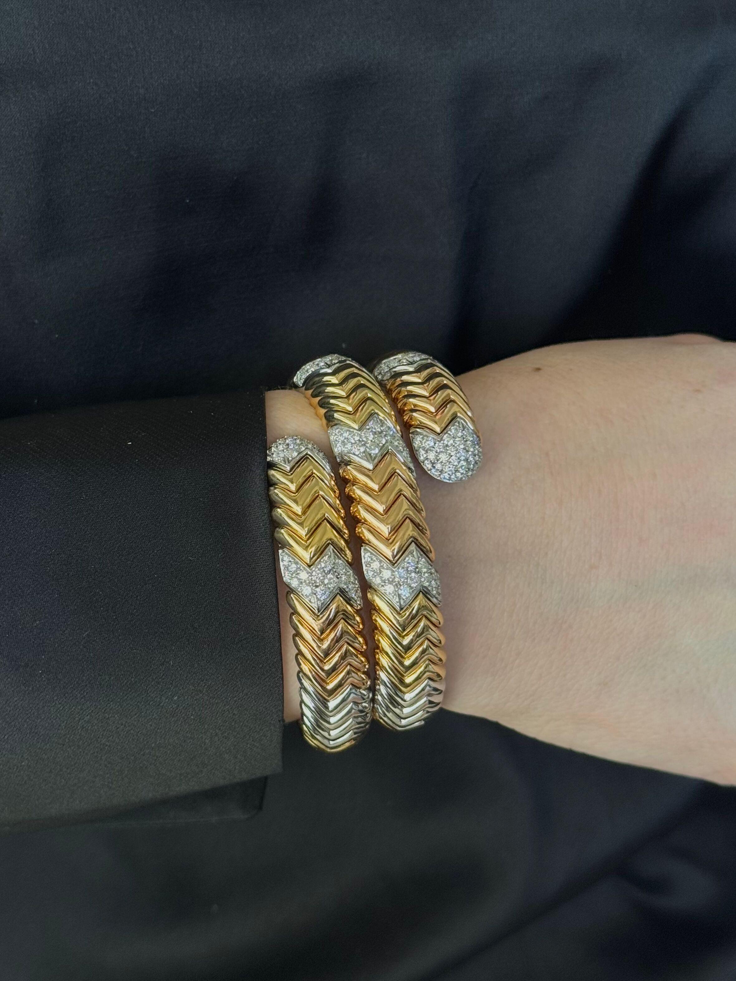 Impressive 18k rose, white and yellow gold bracelet by Bvlgari from iconic Spiga collection. Adorned with approx. 5.40ctw G/VS diamonds. Bracelet has a slightly flexible design, will fit an approx. 6.5