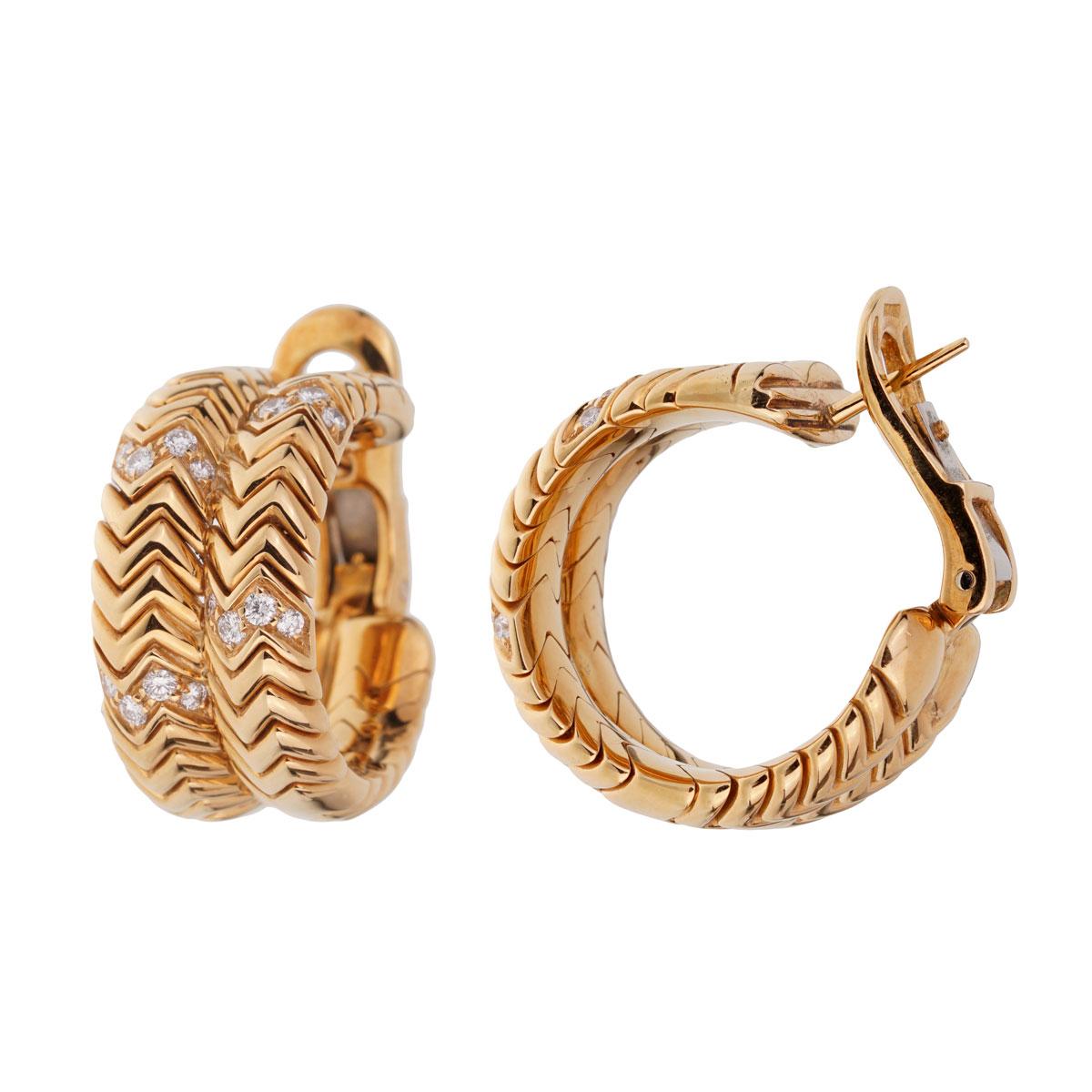 An iconic pair of Bulgari Spiga diamond earrings showcasing the chevron pattern adorned with the finest Bulgari round brilliant cut diamonds in 18k yellow gold.

.90