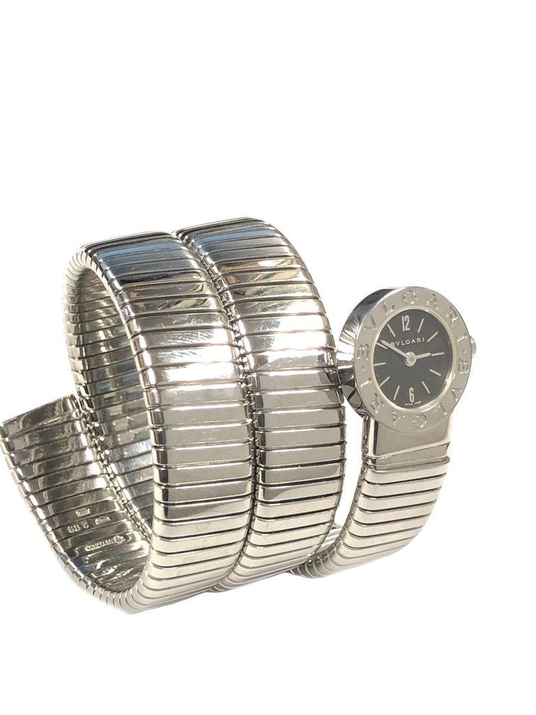 Bulgari Tubogas Wrap around Bracelet wrist watch, 1/2 inch wide coiled Stainless Steel, flexible to fit almost any wrist size. 
28 MM Watch head, quartz Movement, Black dial with steel raised Markers. 
Excellent condition. 
Recently serviced and