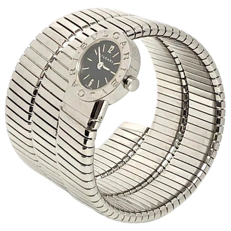 Bulgari Tubogas Wrap around Bracelet wrist watch, 1/2 inch wide coiled Stainless Steel, flexible to fit almost any wrist size. 
28 MM Watch head, quartz Movement, Black dial with steel raised Markers. 
Excellent condition. 
Recently serviced and