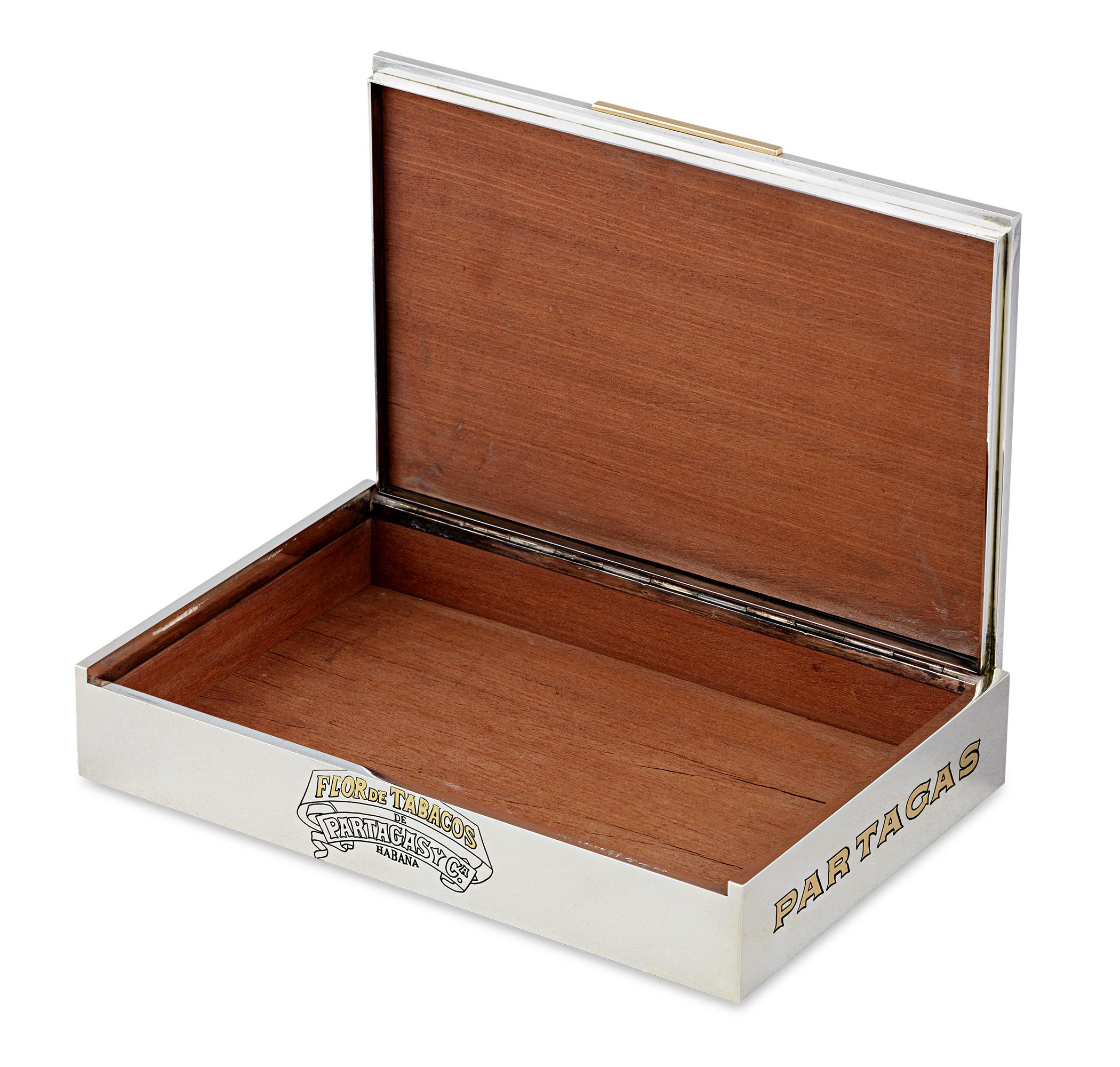 Sterling Silver and Gold Partagás Cigar Box
Bulgari
Dated 1976

This exceptional Bulgari sterling silver and gold cigar box embodies the height of Italian luxury and craftsmanship. The rectangular box is crafted from solid sterling silver and
