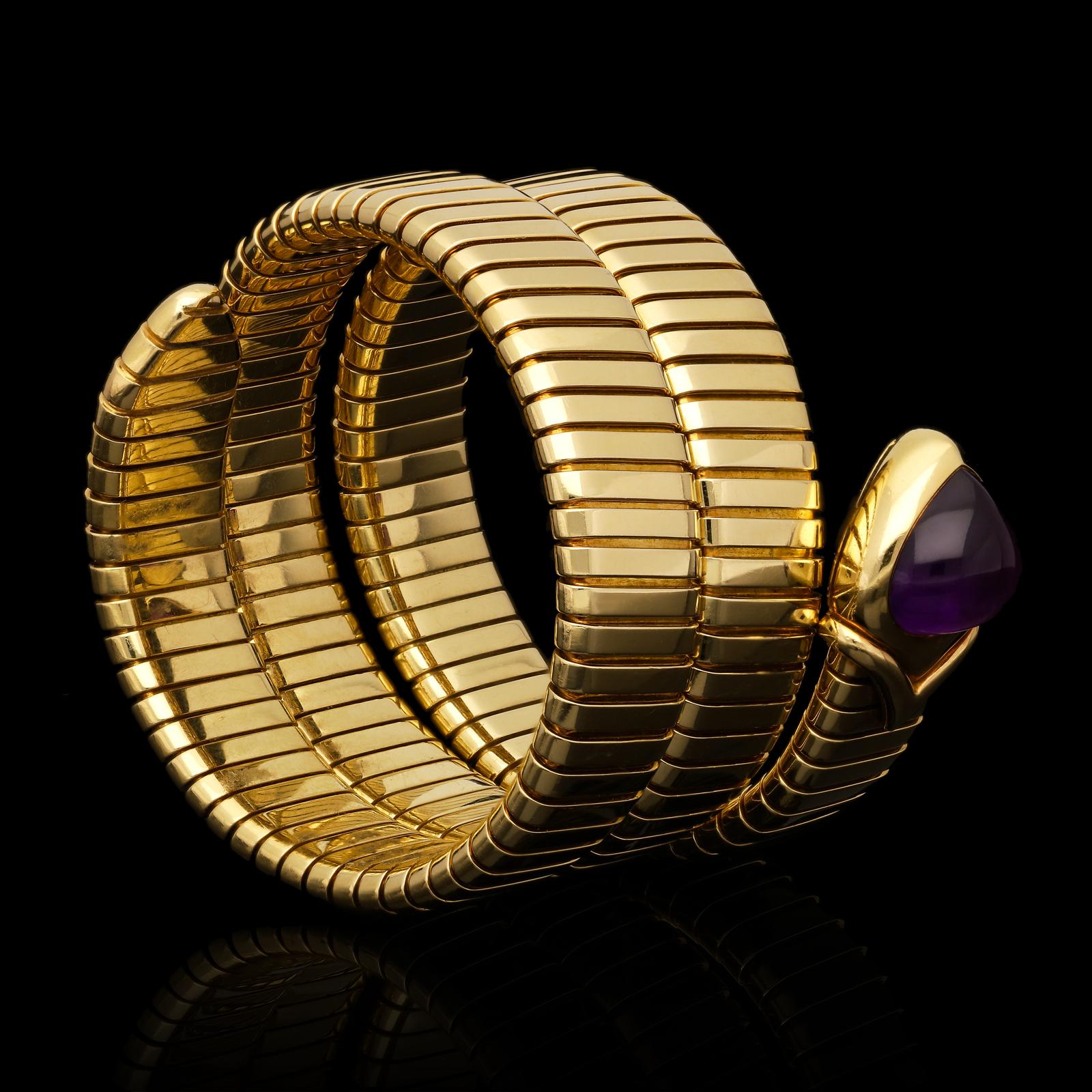 A Gold Bulgari Serpenti Tubogas bracelet c.1980s, the bracelet of stylised serpent design and of flexible sprung form with the iconic Tubogas slanted linear pattern, it wraps around the wrist two and a half times, the head set with a wide