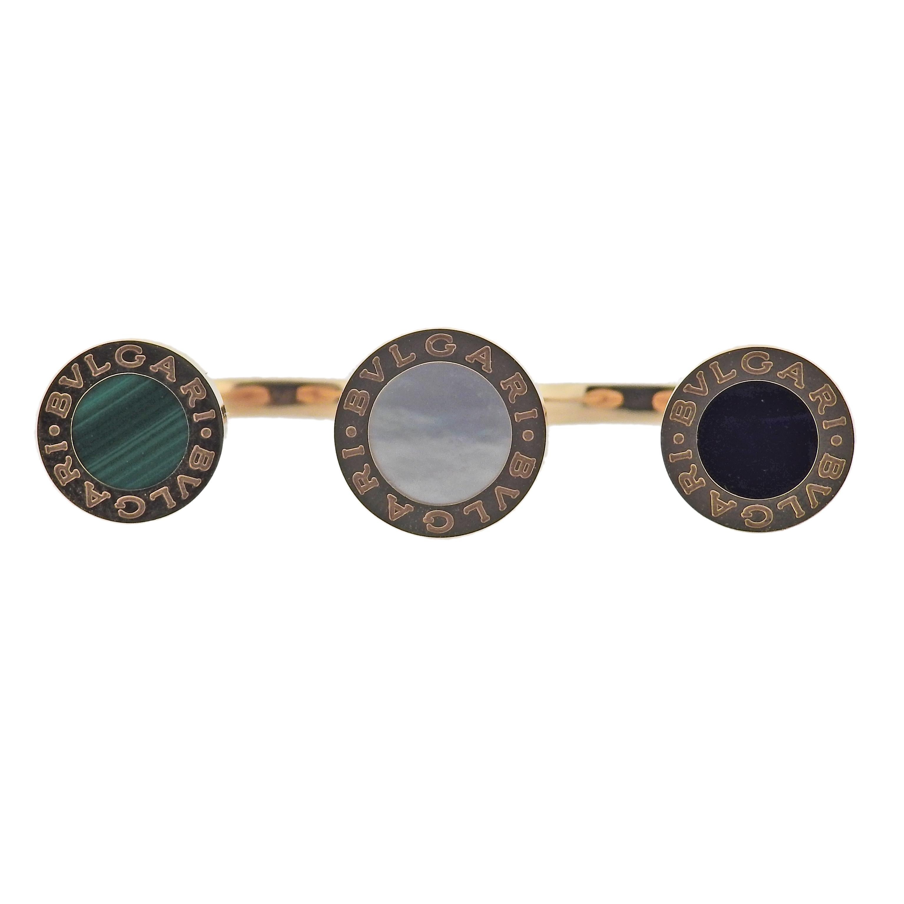 18k rose gold Bvlgari double finger ring, with malachite, sugilite and mother of pearl. Retail $3700. Comes with COA and box. Ring size 6 and 7, tops are 10mm and 11mm in diameter.  Marked Bvlgari, made in Italy, Italian mark, 750, Serial number, M.