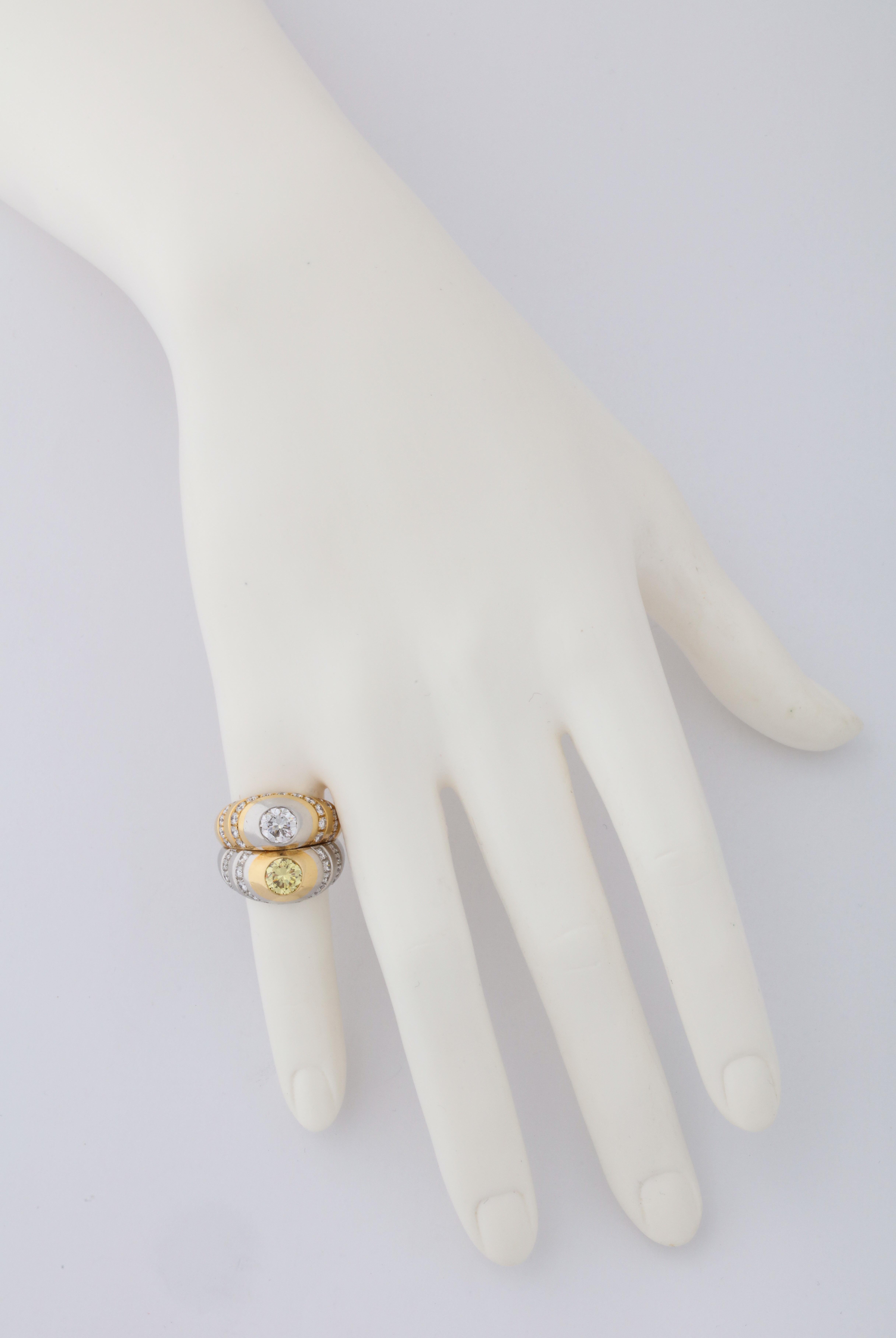 18kt yellow gold and platinum ring featuring a pair of round diamonds- one white (1.01cts) and one yellow (1.09cts), by Bulgari.  Signed, hallmarked and numbered with the diamond weights engraved on the inside of the ring.  A unique, and likely one