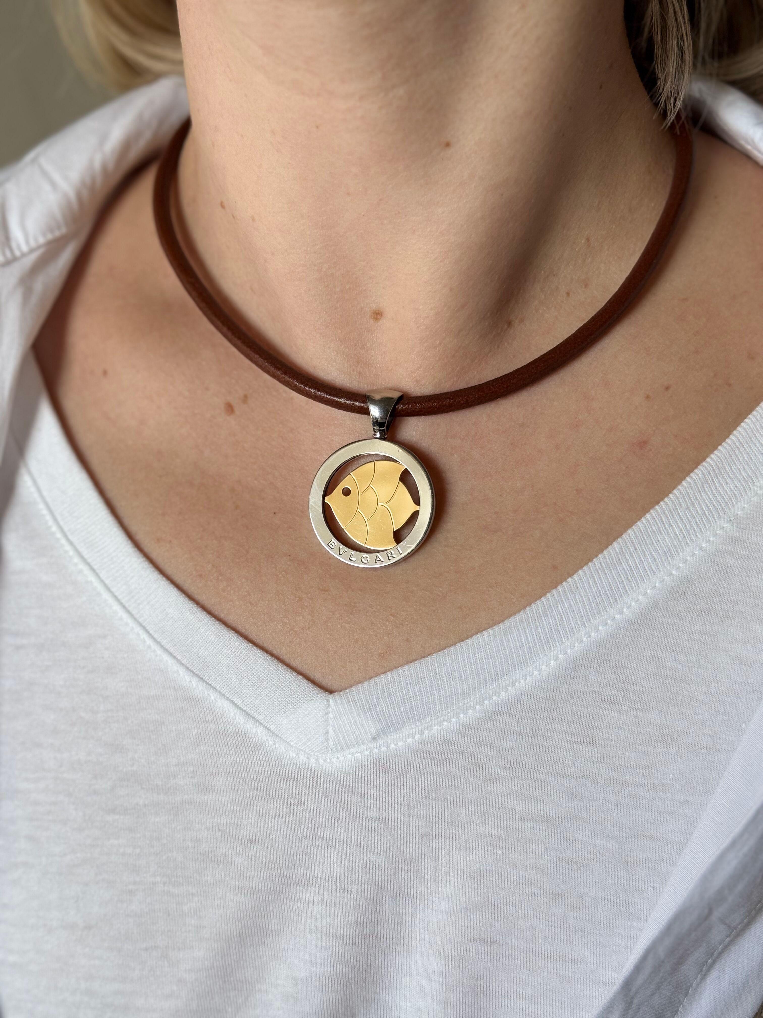 18k yellow gold and stainless steel Tondo fish pendant (medium size), by Bvlgari, suspended on a brown leather Bvlgari necklace with steel lobster clasp. Necklace is 15.25
