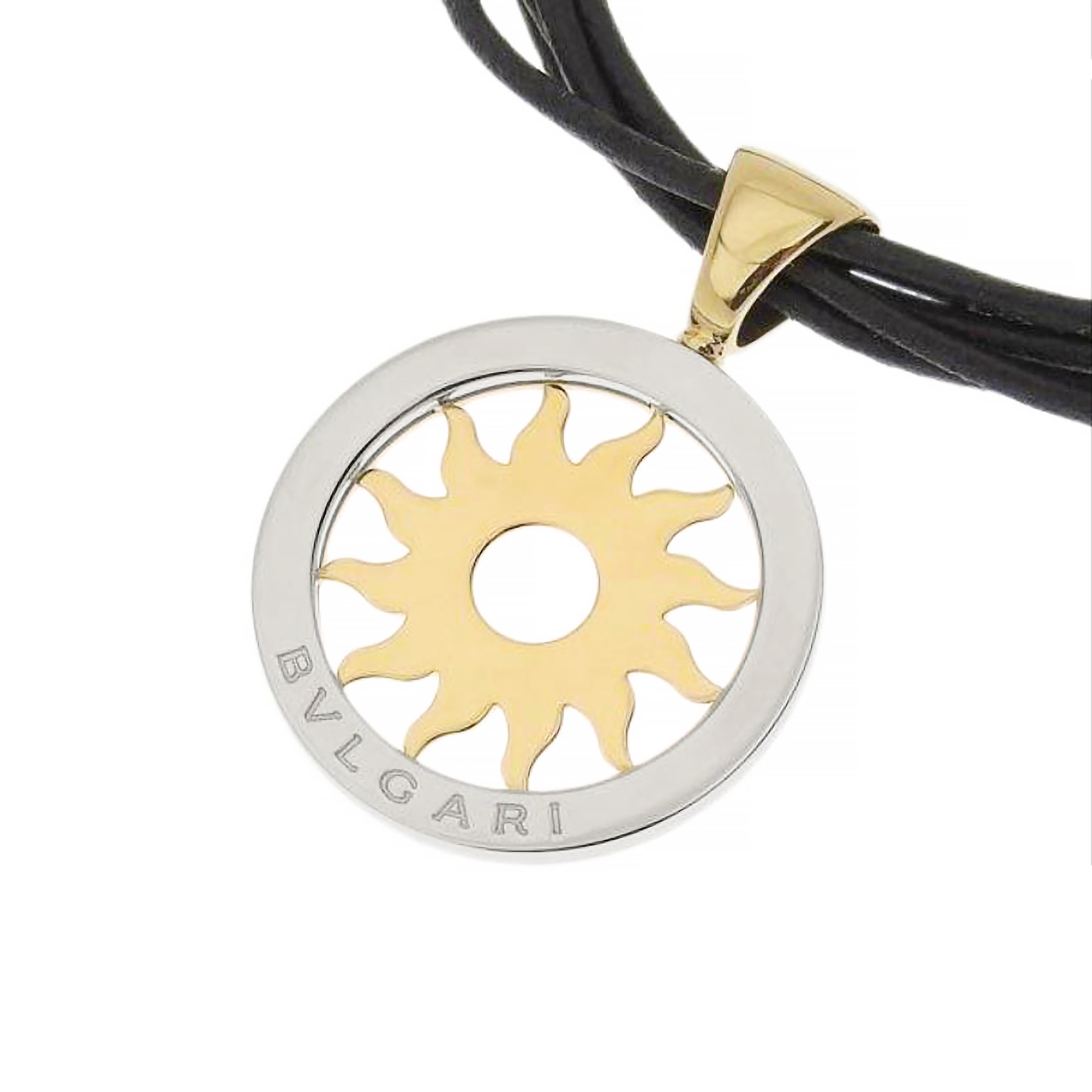 This iconic Bvlgari necklace is from their Tondo collection featuring a stainless steel and yellow gold Tondo sun pendant stamped with the famous BVLGARI signature. This bold pendant comes with a multi strand leather necklace finished with a