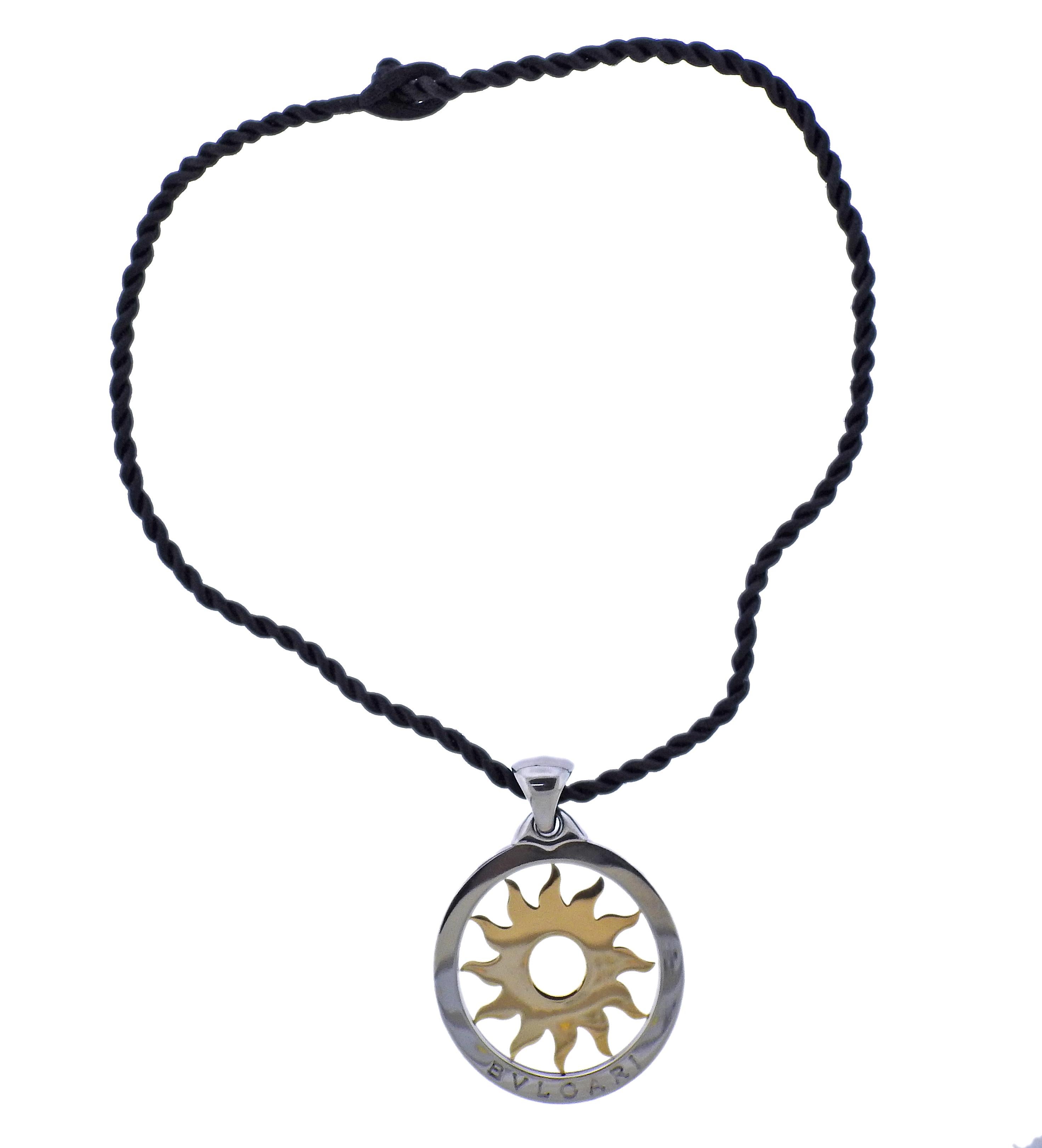 18k gold and steel large Tondo sun pendant by Bvlgari, suspended on an original cord necklace. Cord necklace is 18