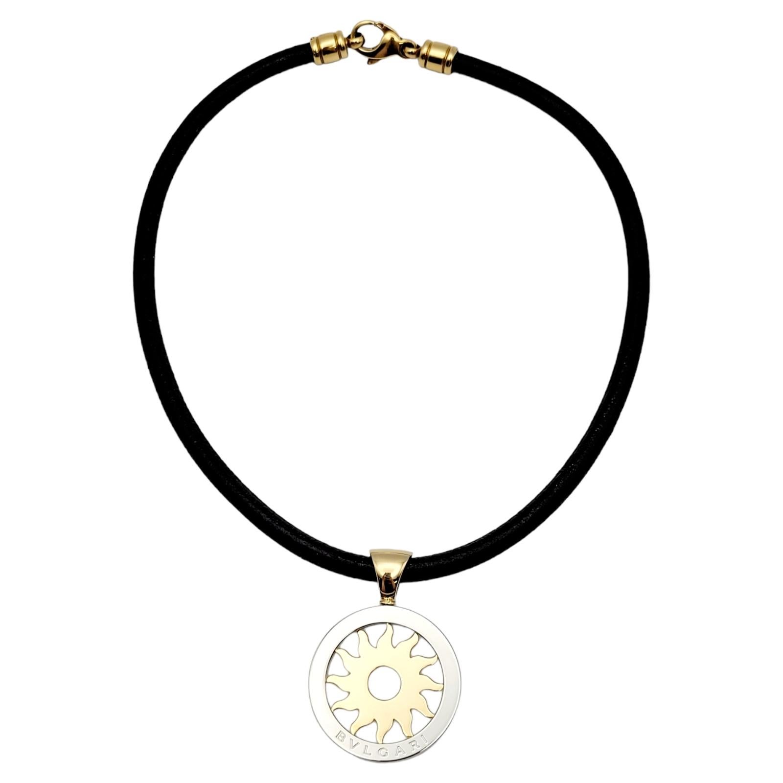 Elevate your jewelry collection with this stunning Bulgari Tondo Sun Pendant Leather Necklace. Crafted with meticulous attention to detail, this exquisite piece showcases a harmonious blend of 18K yellow gold and stainless steel, resulting in a