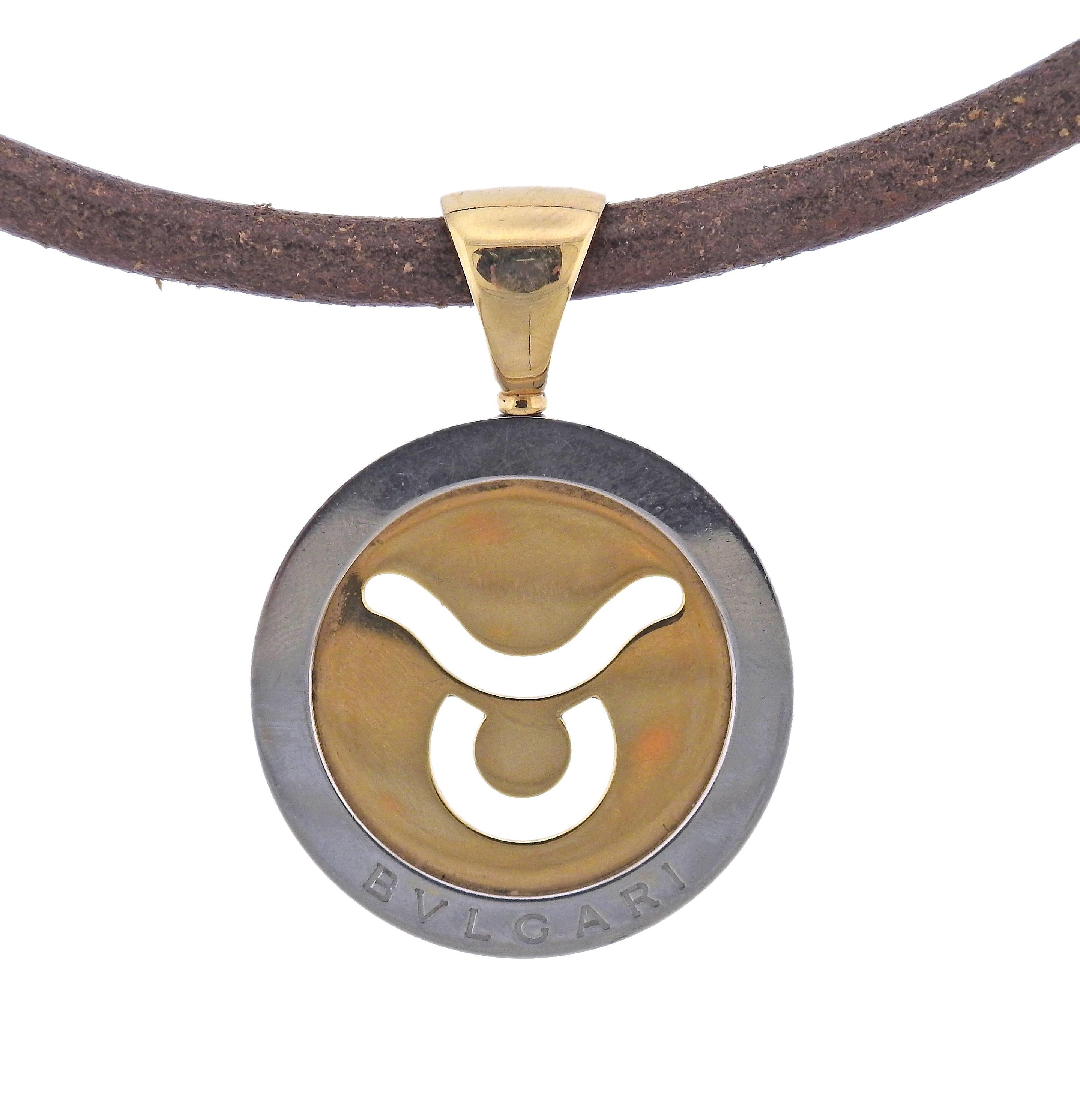 18k gold and stainless steel Tondo Taurus pendant by Bvlgari, on a brown leather and 18k gold cord necklace. Necklace is 15