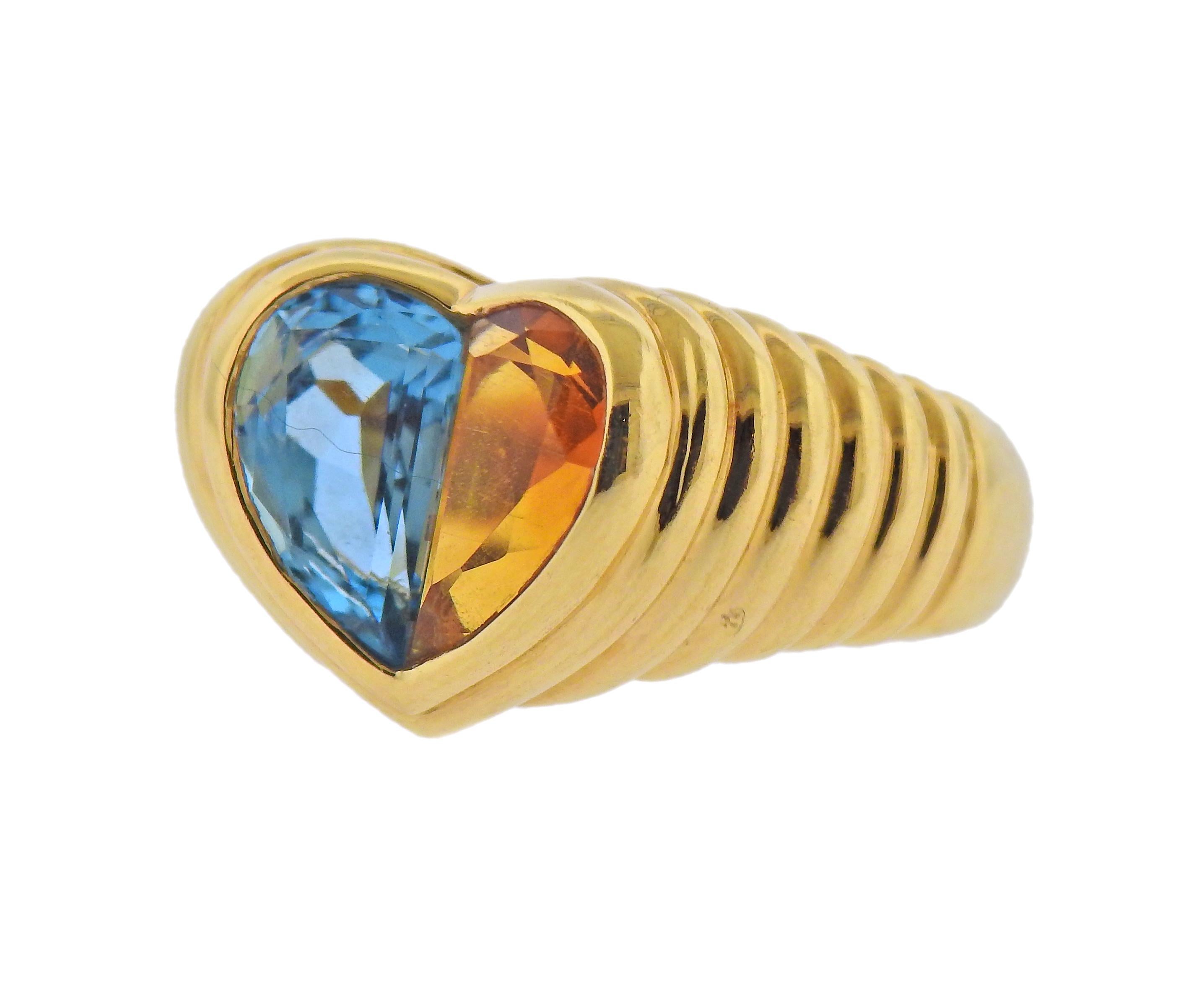 18k yellow gold ring by Bvlgari, set with blue topaz and citing in a heart shaped top. Ring size - 5.25, ring top - 12mm x 11mm. Marked: 750, Italian mark, Bvlgari. Weight - 11 grams.