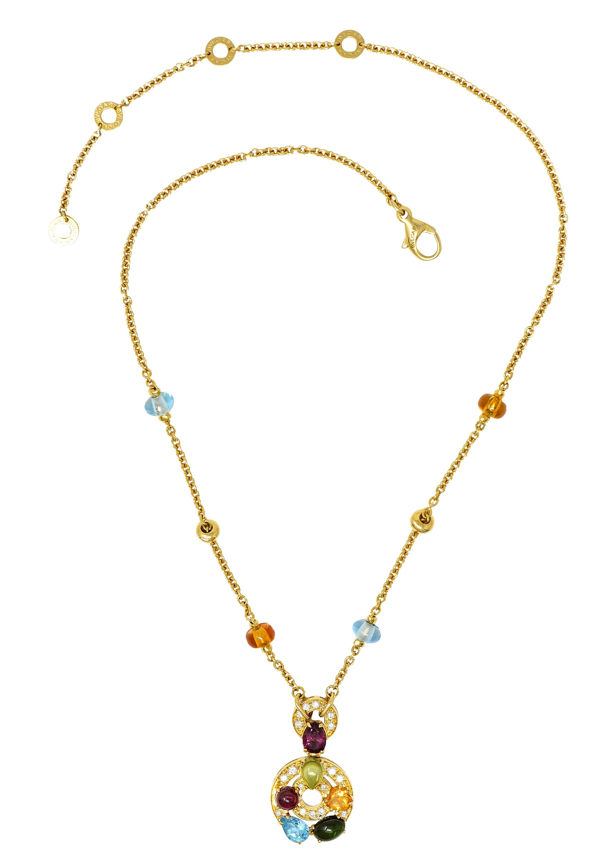 Cable chain necklace has six rondelle stations comprised of polished gold alternating with gemstone beads. Citrine and blue topaz - medium light in saturation and excellent polish. Suspending an articulated drop designed as a concentric circle