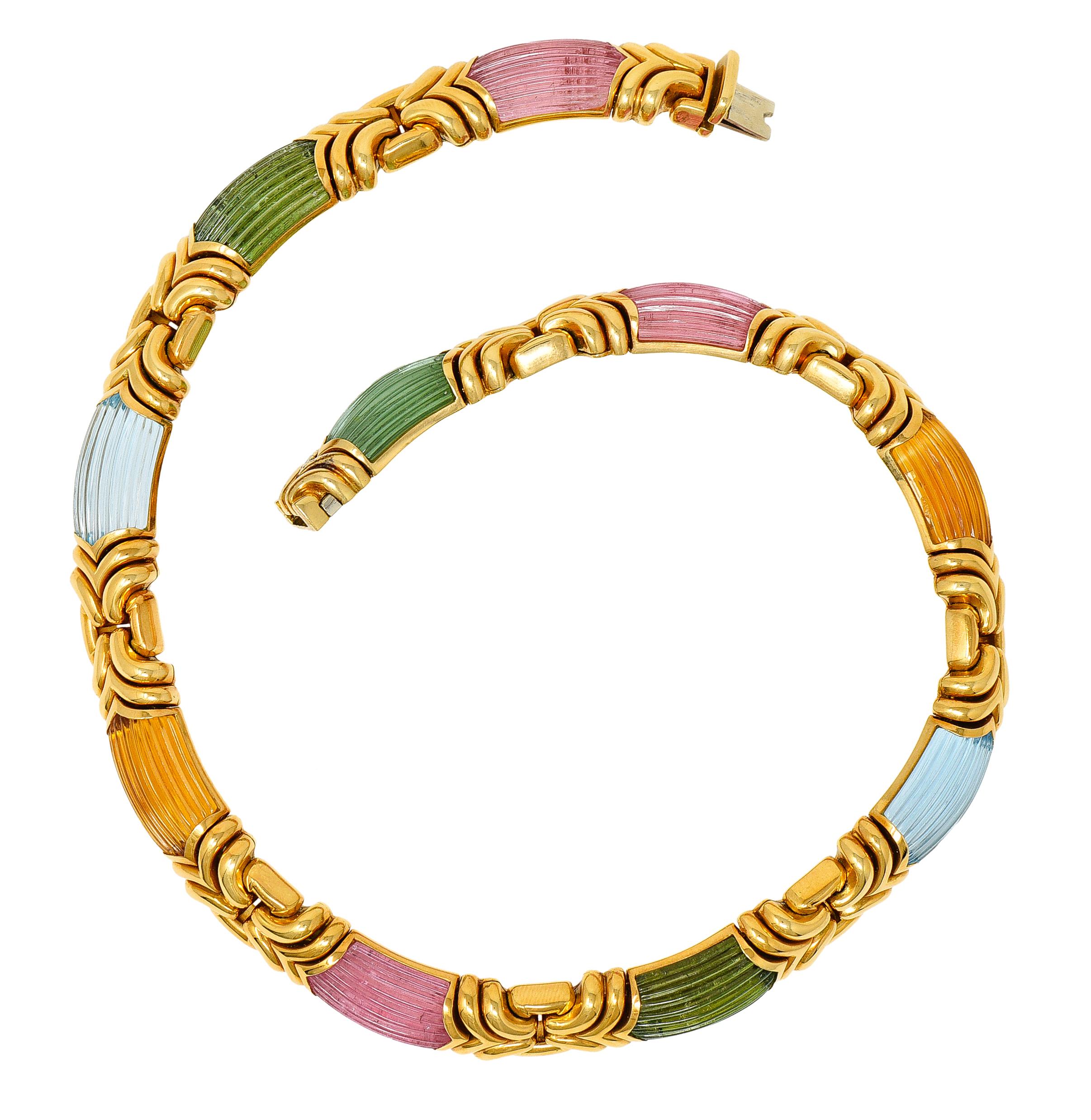 Collar necklace is comprised of chevron gold links in a stylized buckle motif

Alternating with elongated barrel shaped gemstone stations - measuring approximately 22.0 x 10.7 mm

Featuring blue topaz, green tourmaline, pink tourmaline, and citrine