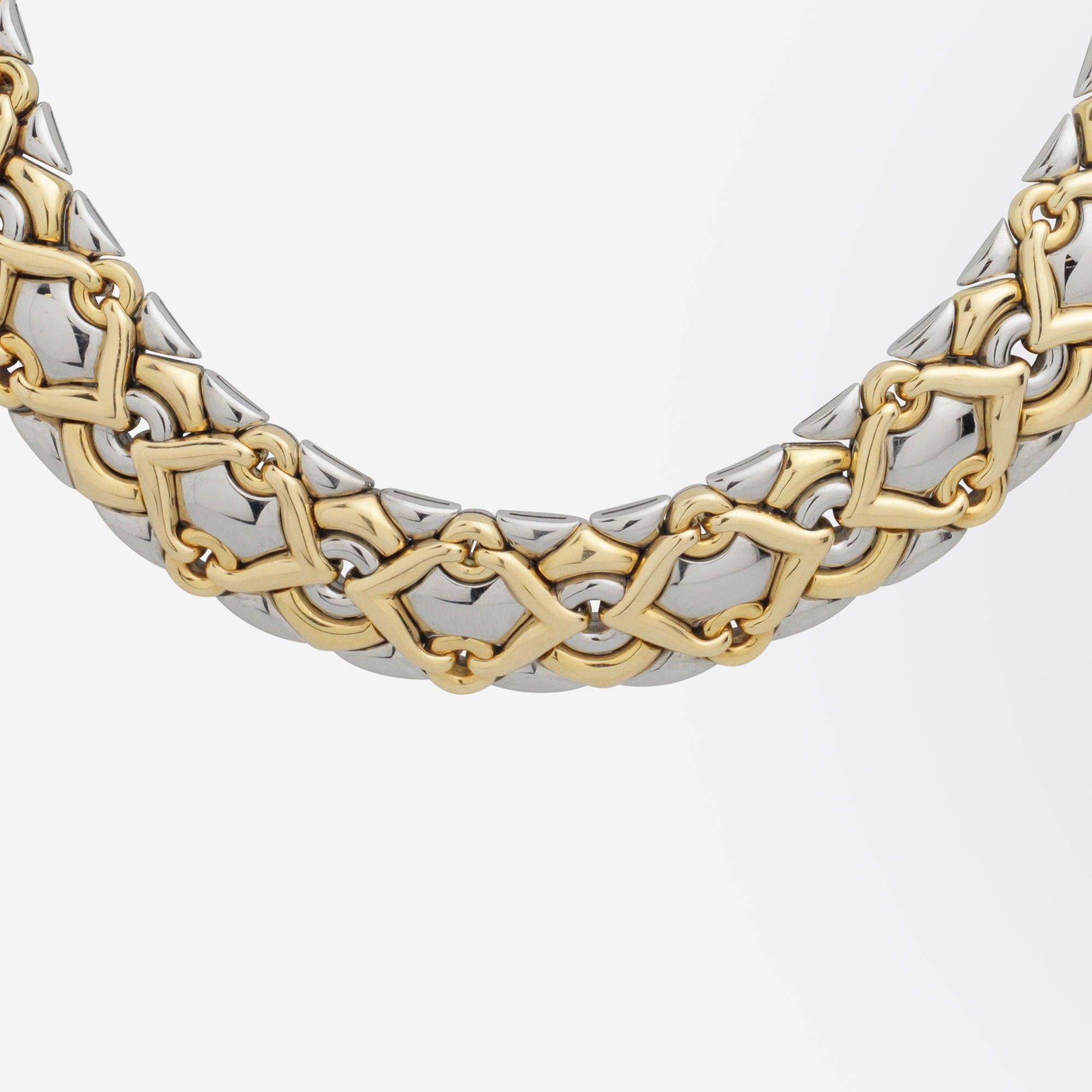 A bold 'Trika' necklet in 18 karat yellow gold and stainless steel by Bulgari. The articulated 'collar' style necklet is a known design called 'Trika' by the famed Italian jeweller and comes in a variety of iterations, from stainless steel to solid