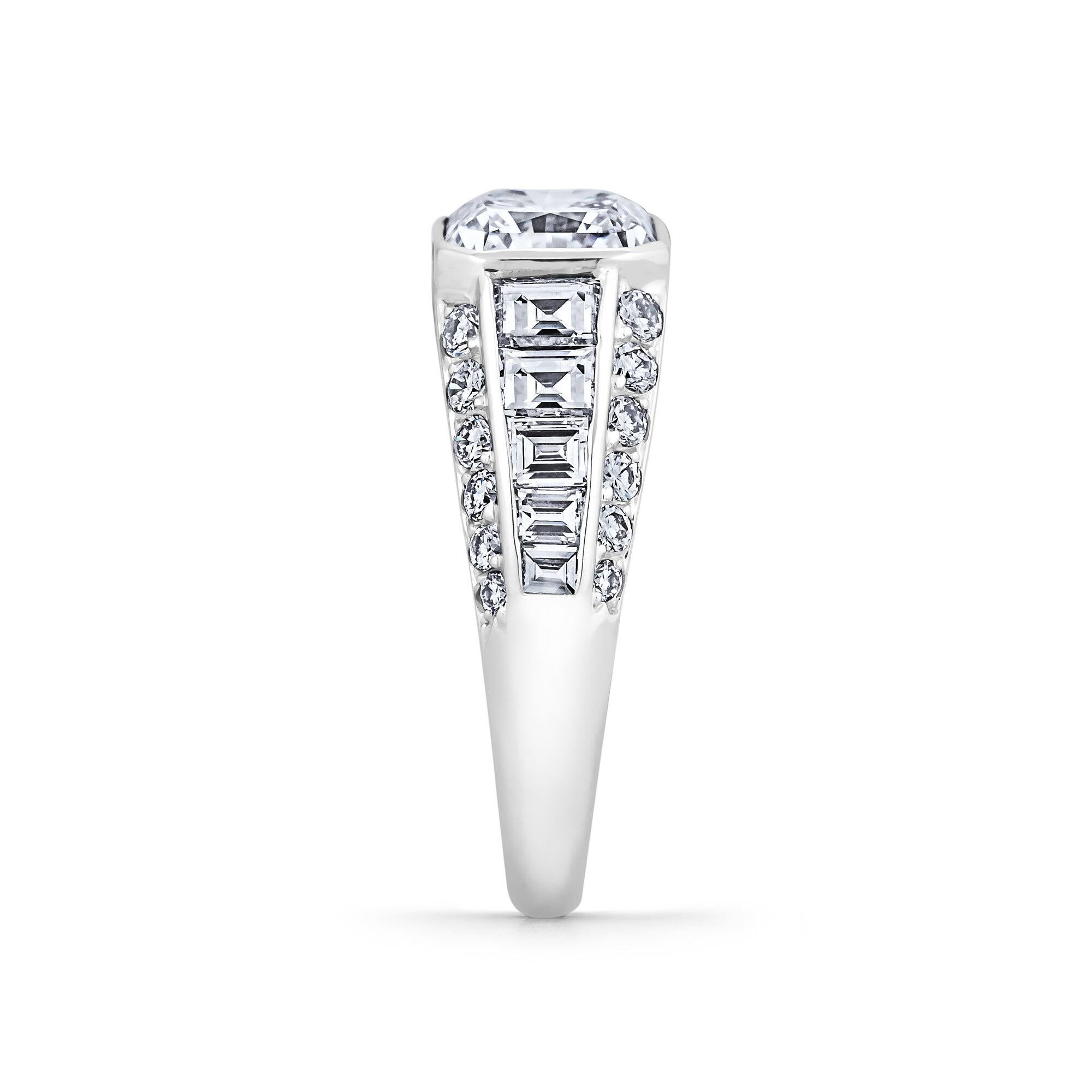 A vibrant 2.69 square radiant cut diamond is the striking centerpiece of this extraordinary Bulgari ring. Surrounded by a total of 1.00 carat of tapered baguette and round cut diamonds mounted in platinum, this extraordinary bombe styled ring will