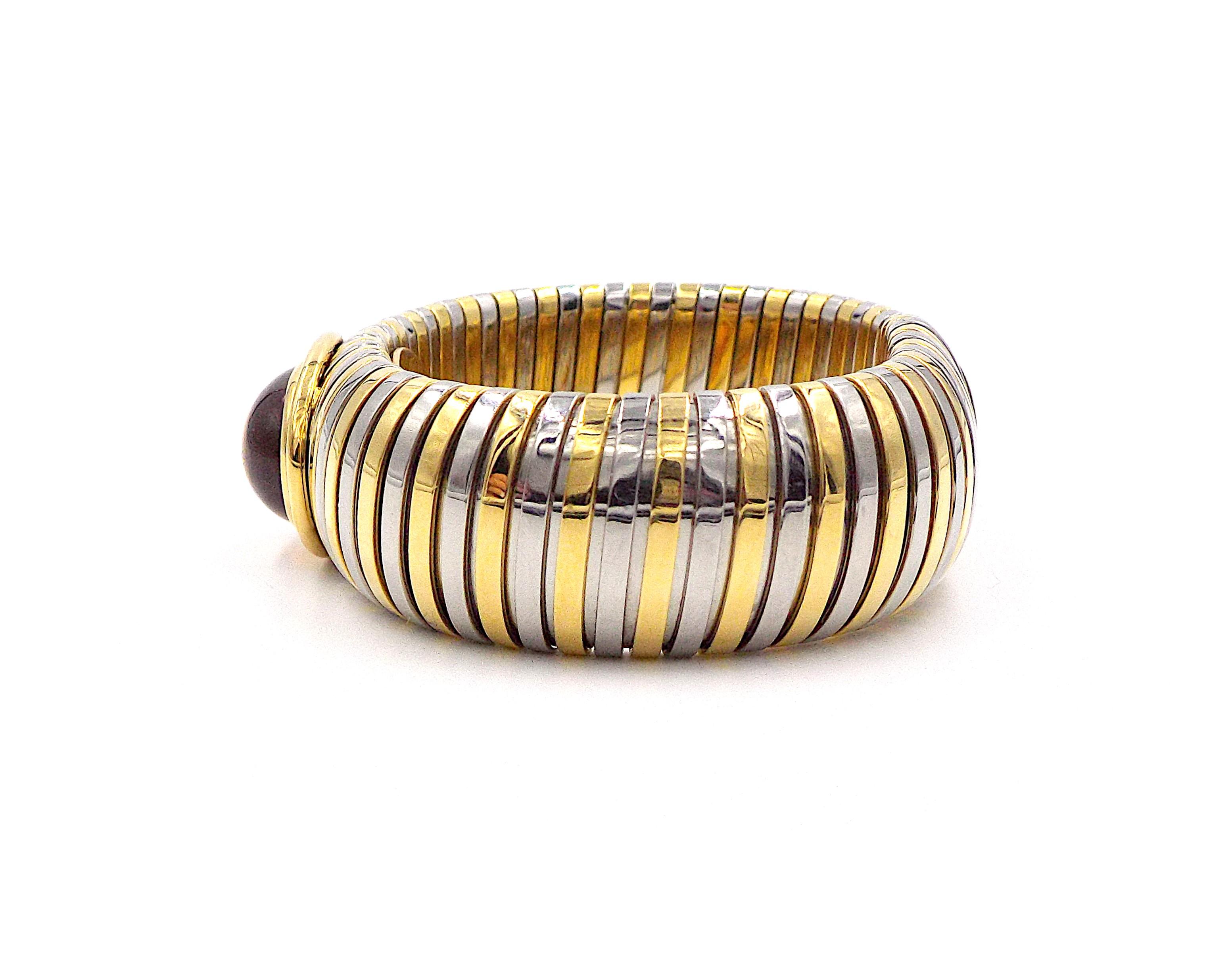 A chic and stylish wide bangle bracelet by Bvlgari made of 18K yellow gold and steel, featuring a large cabochon citrine stone, tubogas model. Min. internal circumference is ap. 6.25