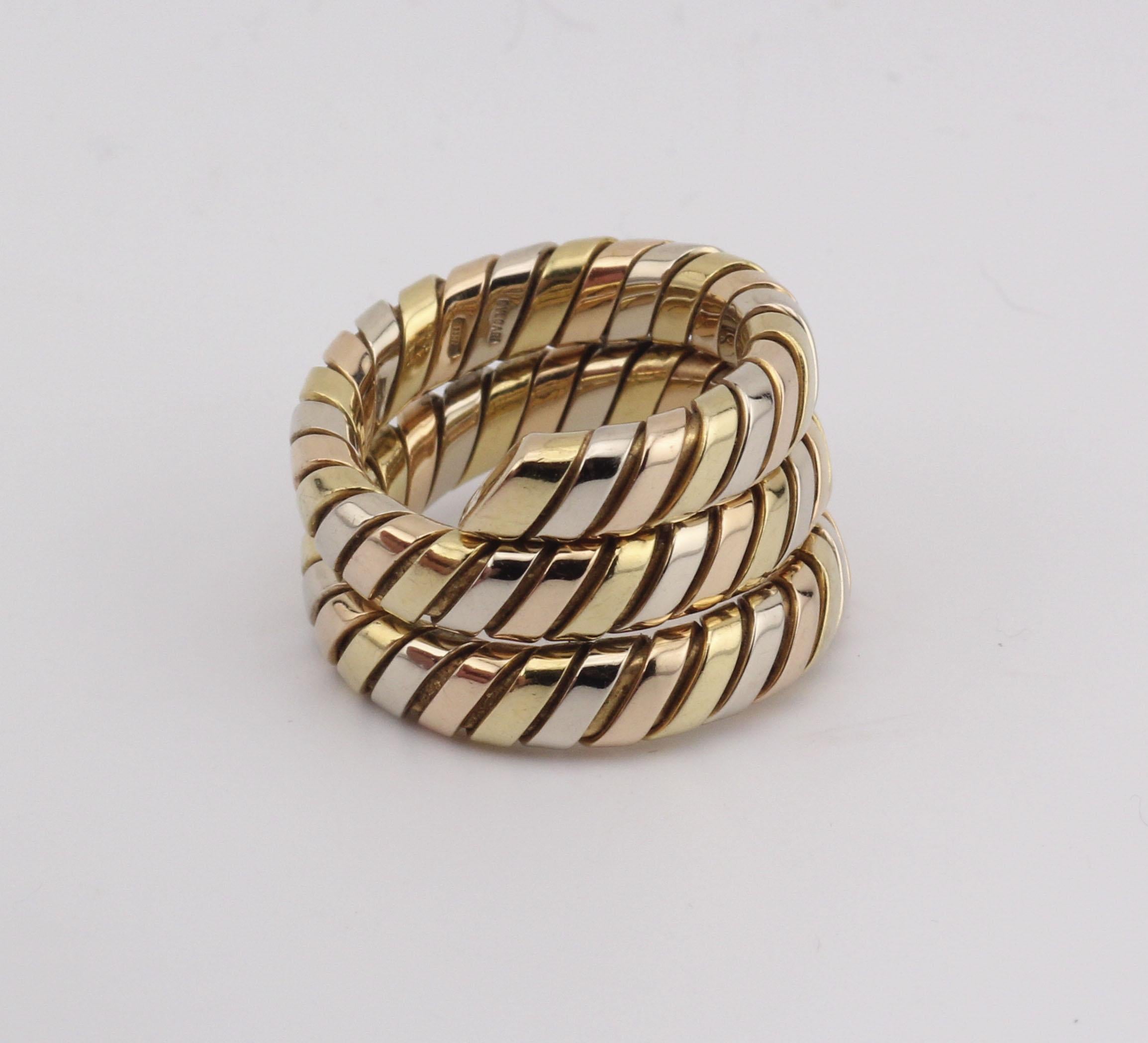 Introducing the Bulgari Tubogas 3 Color 18K Gold Flexible Snake Ring—a mesmerizing blend of iconic design and luxurious craftsmanship from the esteemed Italian jewelry house, Bulgari. This ring is an exquisite representation of the Tubogas