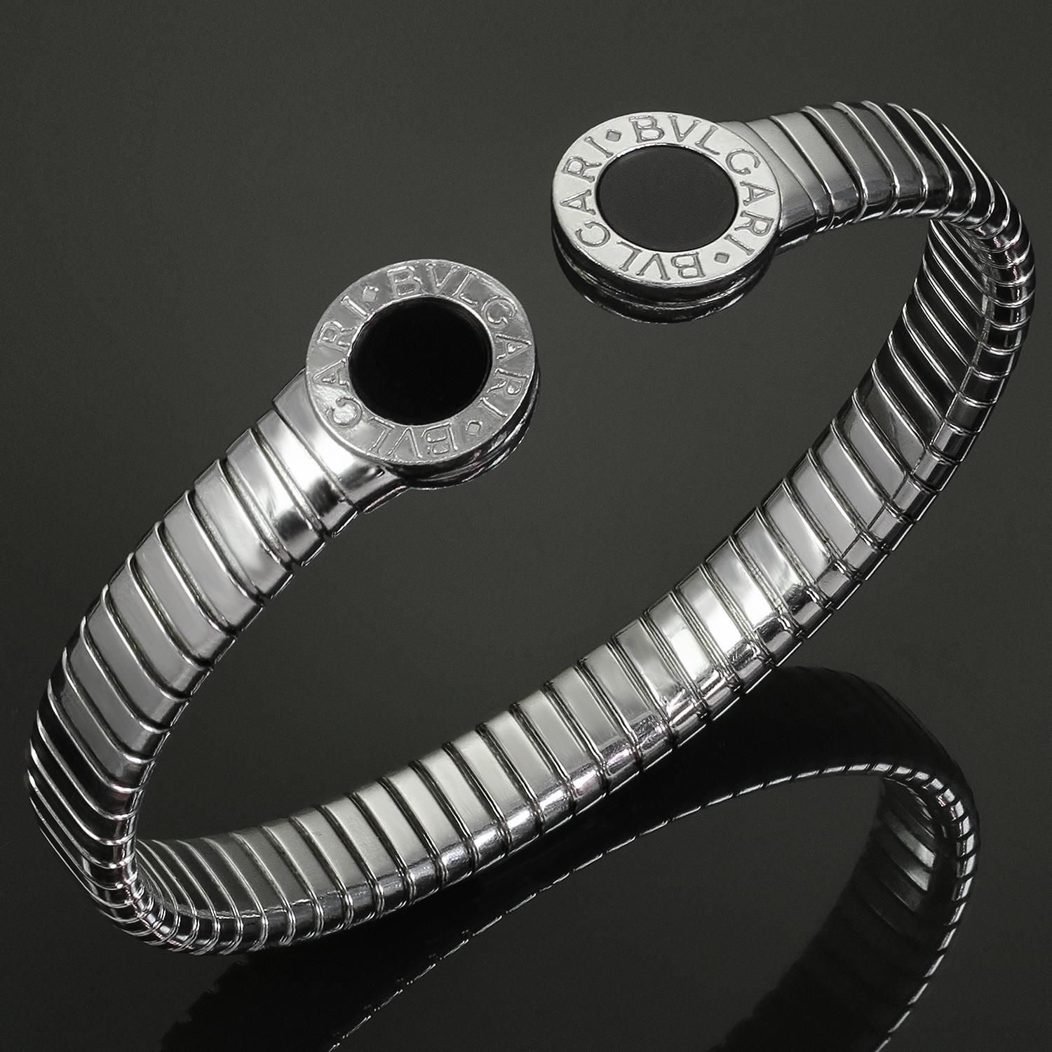 This chic and flexible Bulgari bangle bracelet from the classic Tubogas collection is crafted stainless steel and completed with round black onyx inlays and Bvlgari maker marks. Made in Italy circa 1990s. Measurements: 0.51