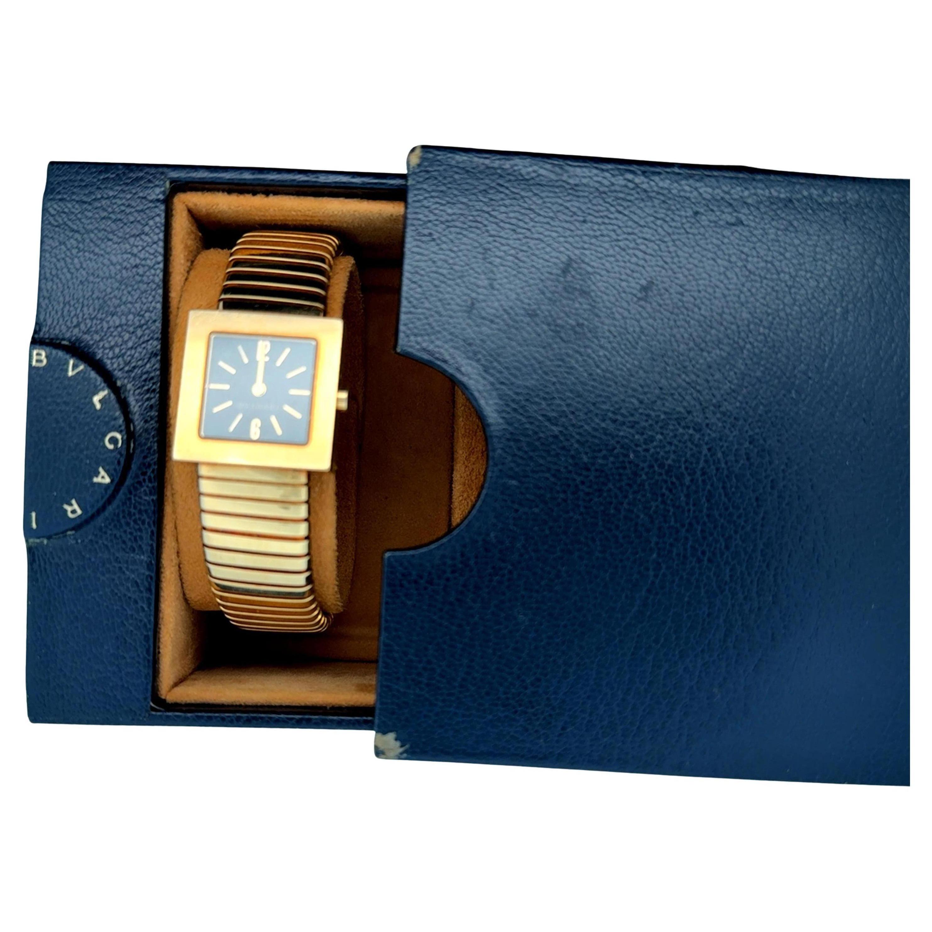 Black dial with gold markers. Bezel measures approx 22mm square. Tubogas band measures approx. 0.20