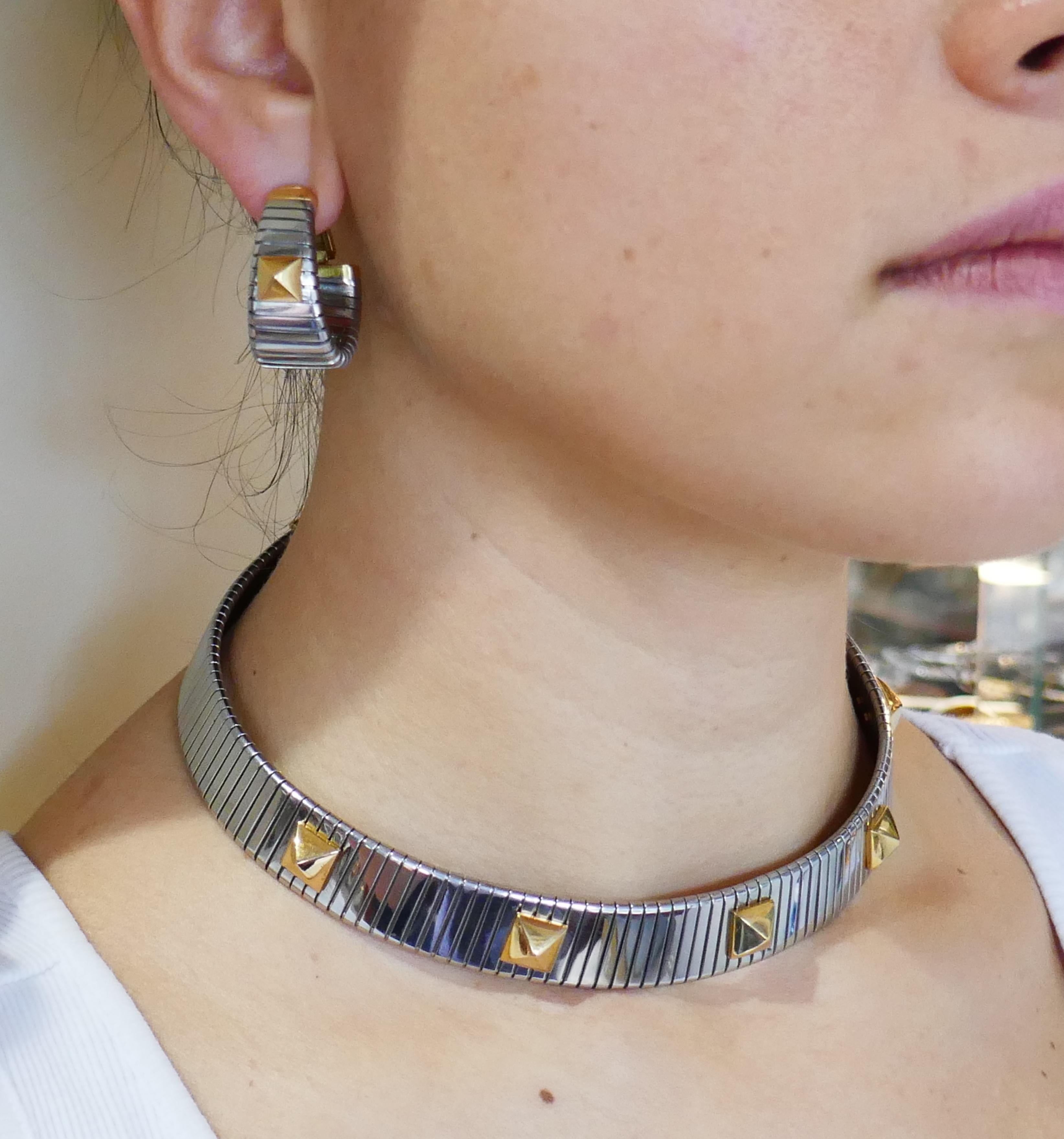 Signature Bulgari tubogas set consisting of a choker necklace and a pair of earrings. Elegant, timeless and wearable,  the set is a great addition to your jewelry collection. 
The set is made of stainless steel and 18 karat (stamped) yellow