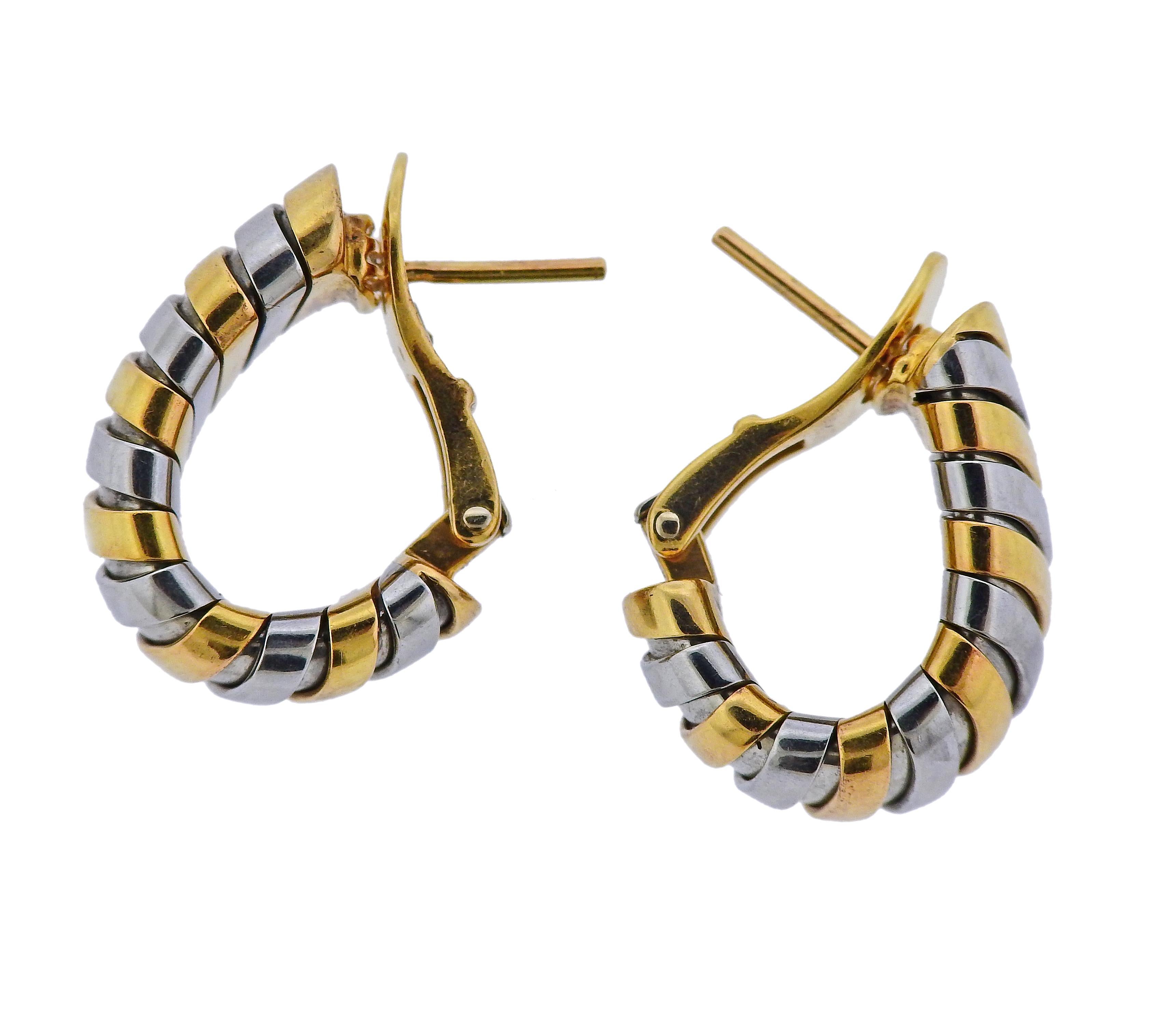 18k yellow gold and stainless steel Tubogas hoop earrings, crafted by Bvlgari. Earrings measure 21mm x 12mm. Marked: Bvlgari, 750, 1106MI, Made in Italy, Gold and Steel. Weight: 18.9 grams.
