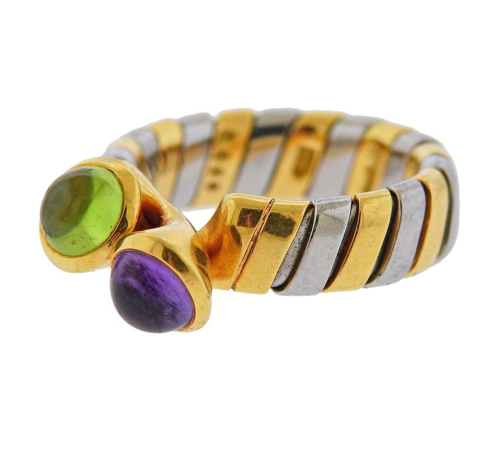 18k gold and stainless steel Tubogas ring, crafted by Bvlgari, set with peridot and amethyst. Ring size - 6.25, ring top - 8mm x 15mm. Weight is 7.7 grams. Marked Bvlgari, 750, 9229, BA.