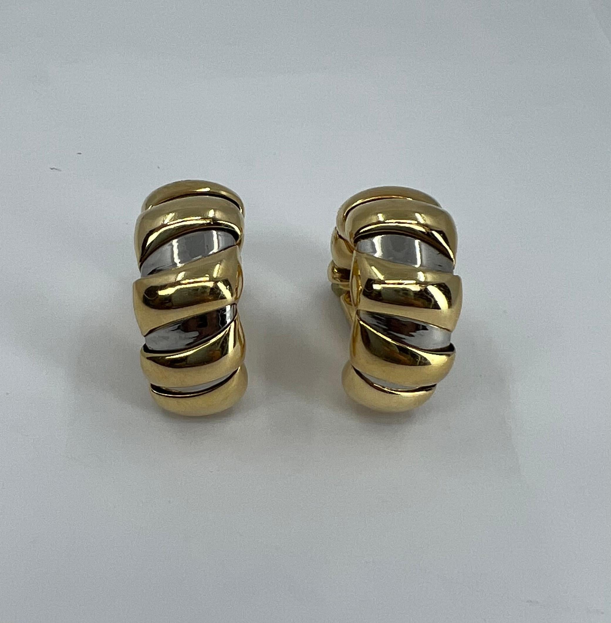 A pair of Bulgari Tubogas earrings in stainless steel and 18k gold.
Iconic Bulgari Tubogas design comes in a wide variety of materials and shapes. These hoop earrings were made by using a stainless steel coil as a base. A thick gold wire is twisted