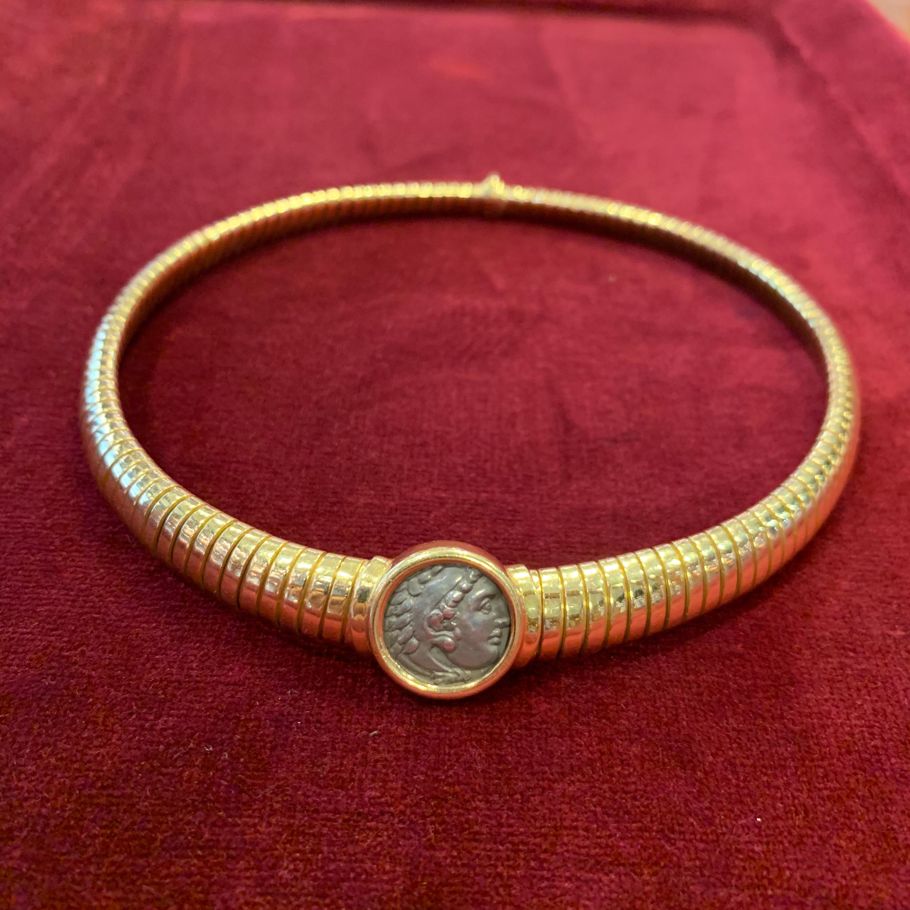 An iconic Bulgari “Monete” tubogas necklace consisting of 18kt yellow gold and an antique Roman coin. Made in Italy, circa 1975.