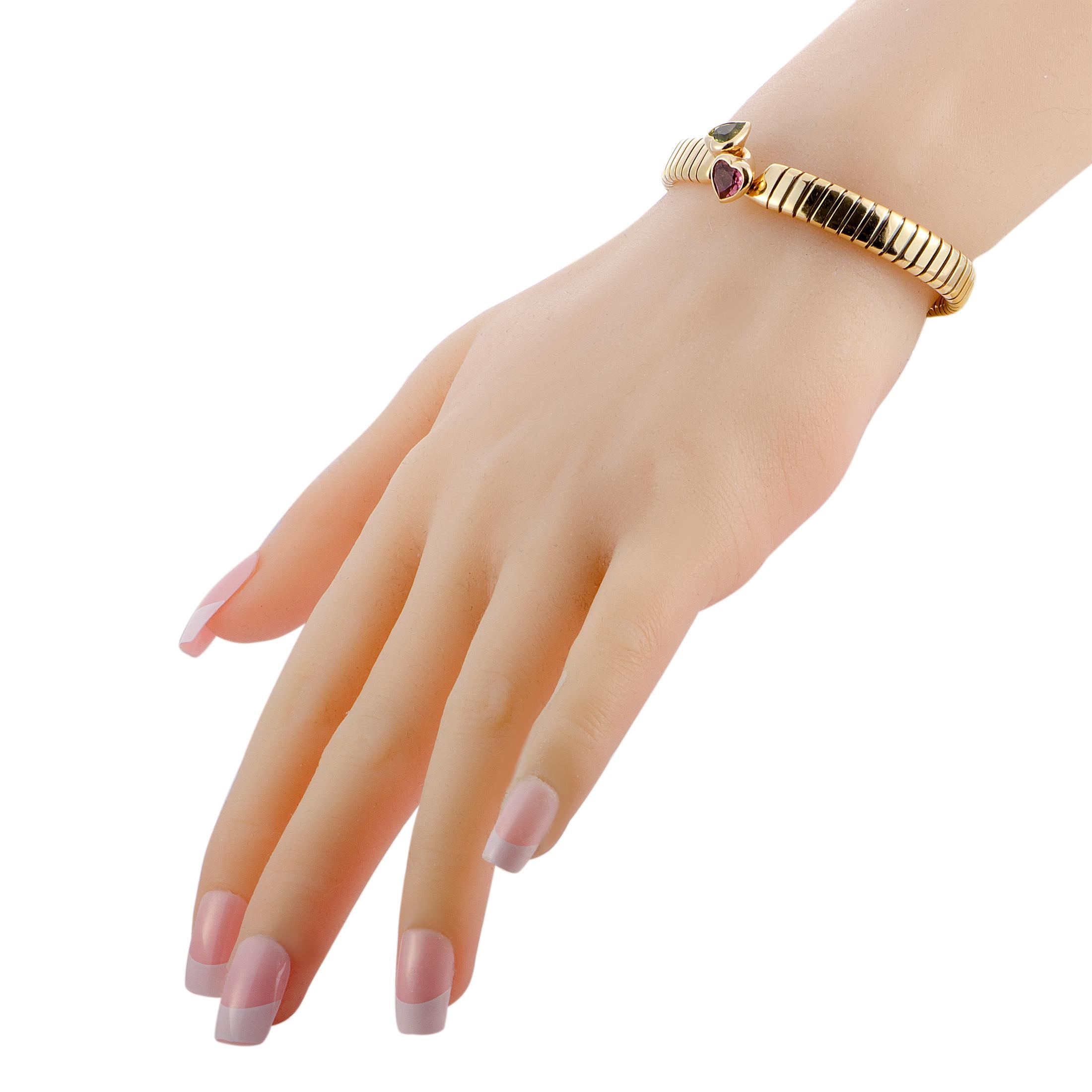 The Bvlgari “Tubogas” bracelet is crafted from 18K yellow gold and set with a peridot and a tourmaline. The bracelet weighs 26.9 grams and measures 7.40” in length with a 2.37” diameter.

This jewelry piece is offered in estate condition and