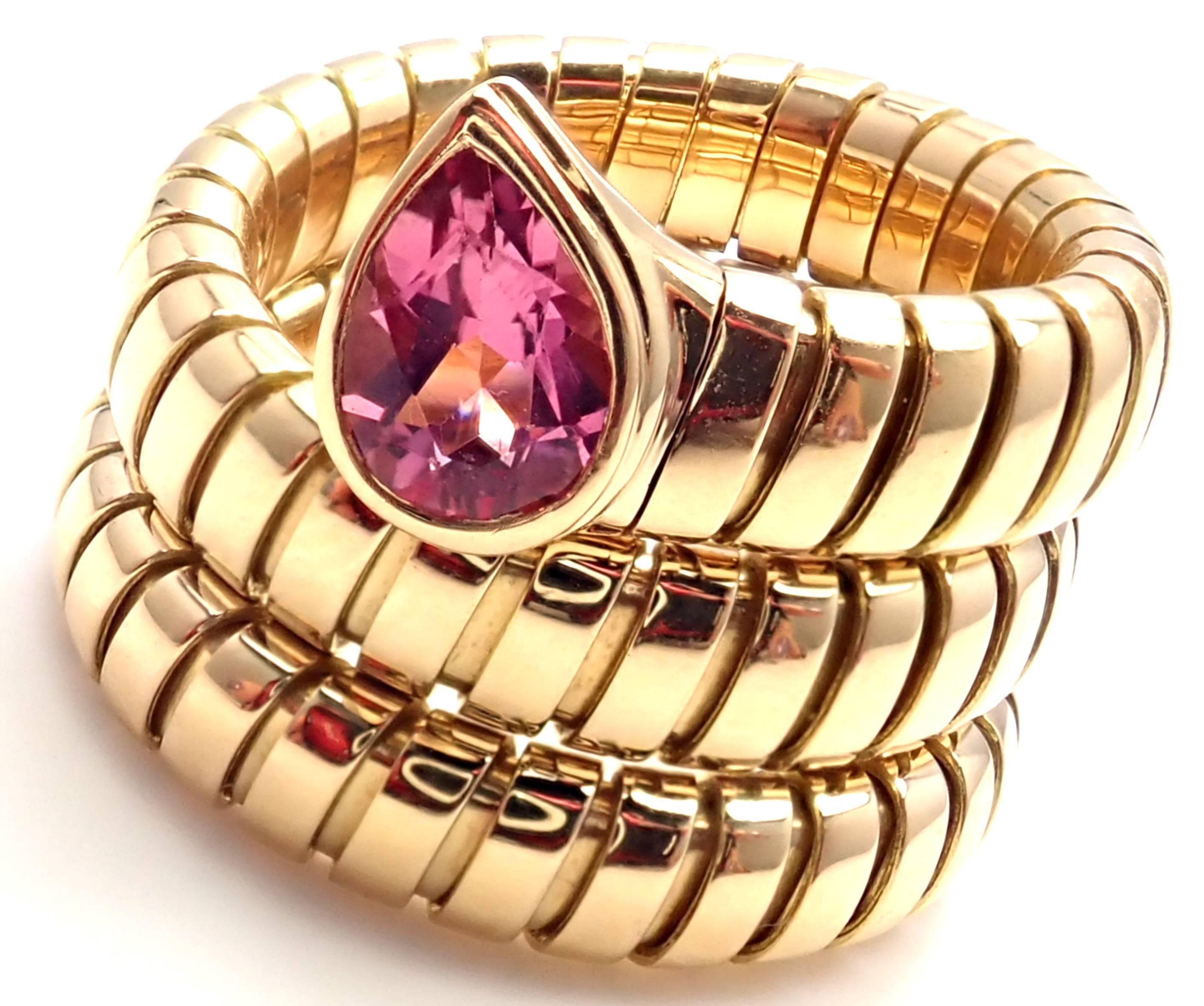 18k Yellow Gold Pink Tourmaline Coil Snake Band Ring by Bulgari. 
With 1 pear shape pink tourmaline stone: 6mm x 4mm.
Details:
Ring Size: 6-6.5 (the ring stretches)
Width: 18mm
Weight: 15.6 grams
Stamped Hallmarks:  Bvlgari 750 
*Free Shipping