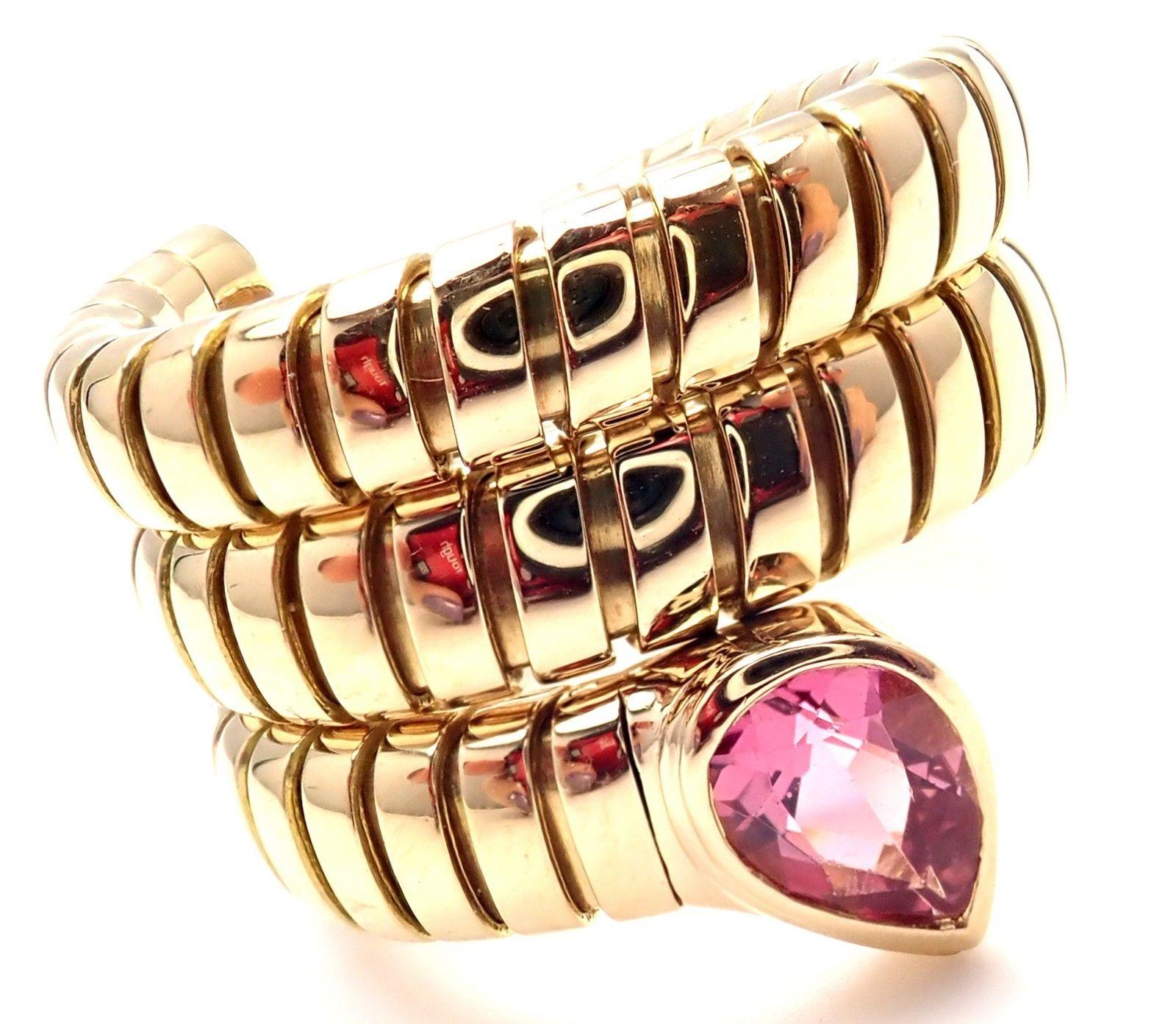 18k Yellow Gold Pink Tourmaline Coil Snake Band Ring by Bulgari. 
With 1 pear shape pink tourmaline stone: 6mm x 4mm.
Details:
Ring Size: 6-6.5 (the ring stretches)
Width: 18mm
Weight: 14.5 grams
Stamped Hallmarks: Bvlgari 750 
*Free Shipping within