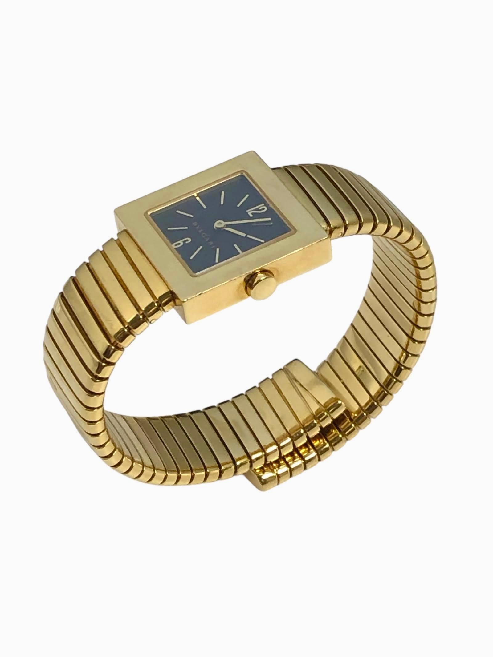 Circa 2000 Bulgari Tobogas Quadrato Ref: SQ 22 2T Cuff Wrist Watch, 22 x 22 M.M. 18k Yellow Gold 2 piece Square case, 4.5 M.M. thick, Black dial with raised Gold markers, Quartz movement, Sapphire Glass Crystal. 5/8 inch wide flexible Tubogas