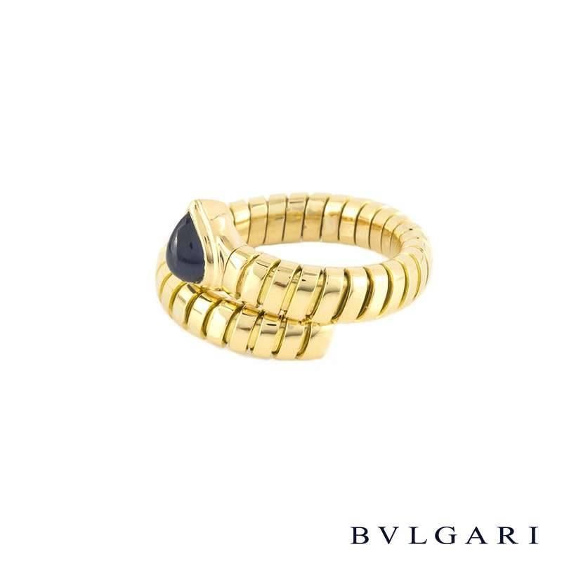 An 18k yellow gold sapphire ring from the Bvlgari Tubogas collection. The ring is features a 1.31ct pear shape cabochon sapphire, set to a flexi link serpant design band. The 5mm ring is a size P, US 7 1/2 but can be adjusted slightly larger and has