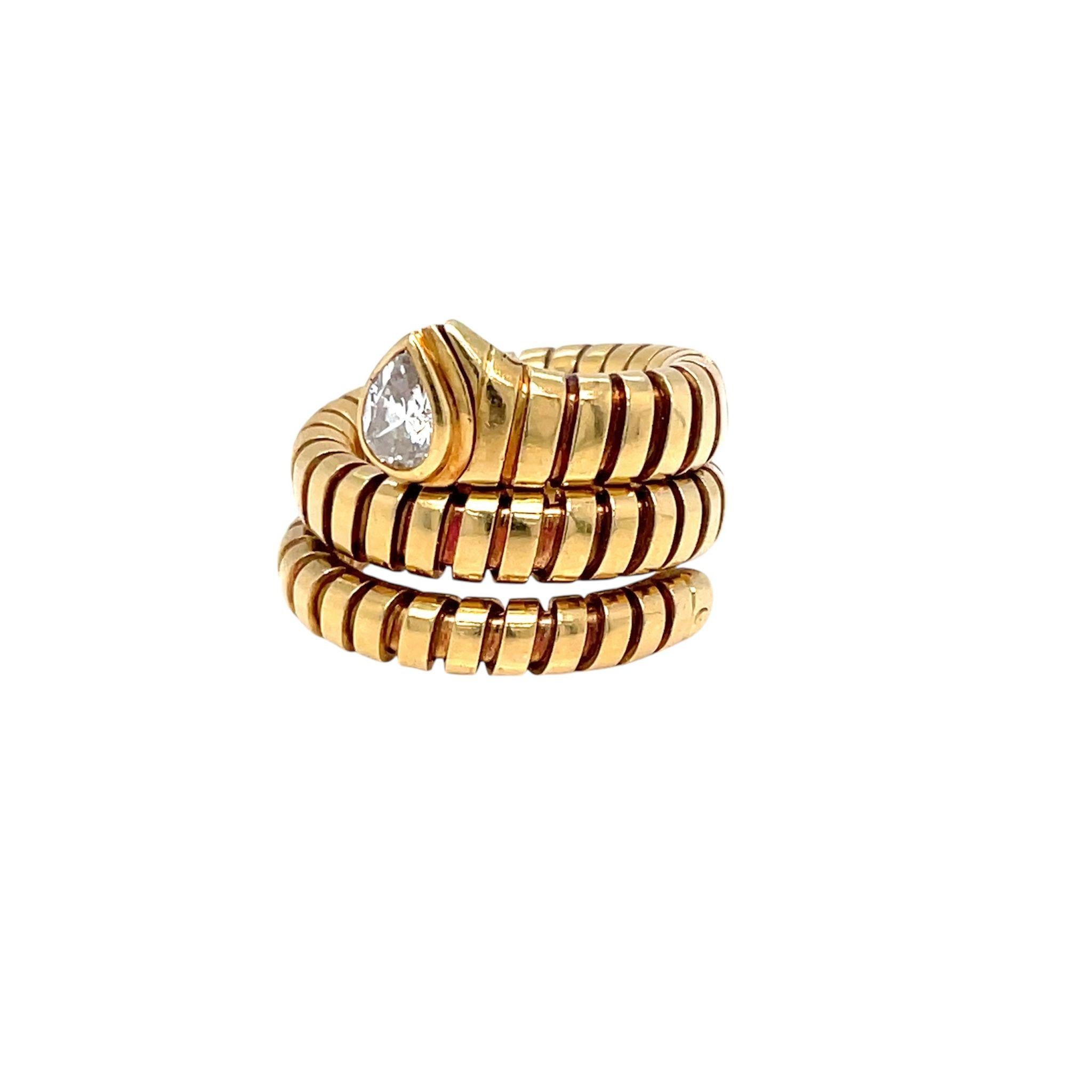 An iconic Bulgari Tubogas ring circa 1980's showcasing 18k yellow gold in a perfectly balanced ring, set with a sparkling pear-cut Diamond, 0,38 carats graded G color Vvs1.
The ring measures a size 4,5. The flexible nature of this ring allows some