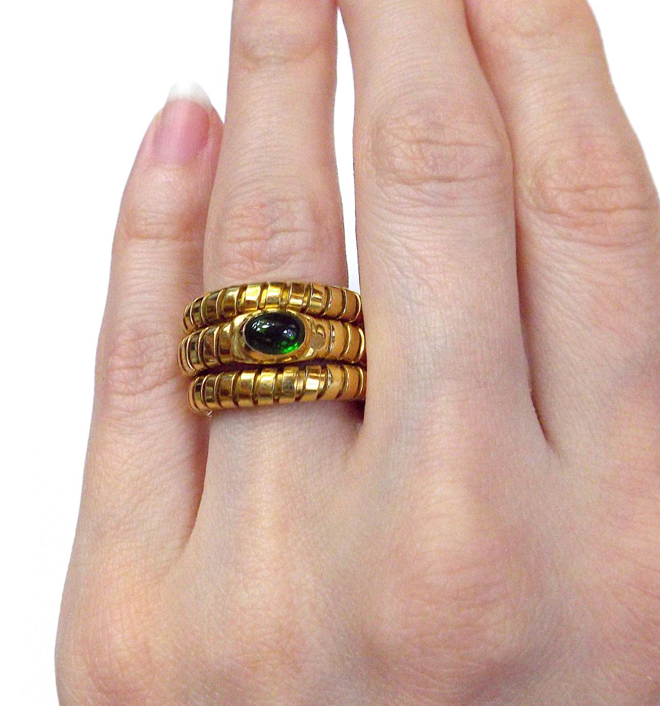 An iconic Bulgari Tubogas ring circa 1980's showcasing 18k yellow gold in a perfectly balanced ring, set with a fancy cabochon Emerald
The ring measures a size 6.5. The flexible nature of this ring allows some play in regards to size.
Hallmarks: