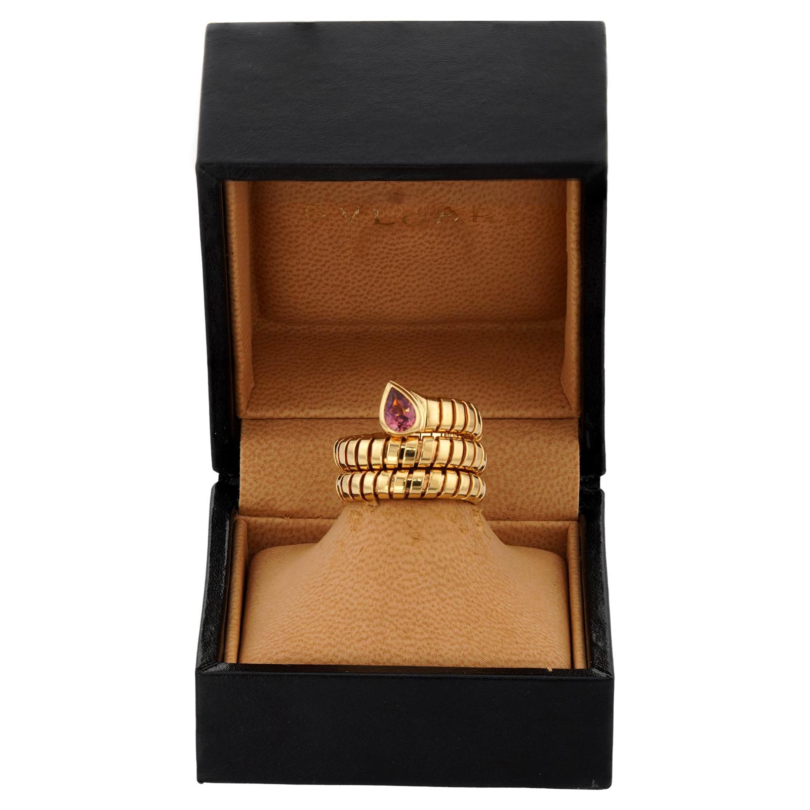 This fabulous Bvlgari Serpenti 3-row ring from the classic Tubogas collection features a slightly adjustable wrap design crafted in 18k yellow gold and accented with a pear-cut pink tourmaline. Made in Italy circa 1990s. Measurements: 0.66