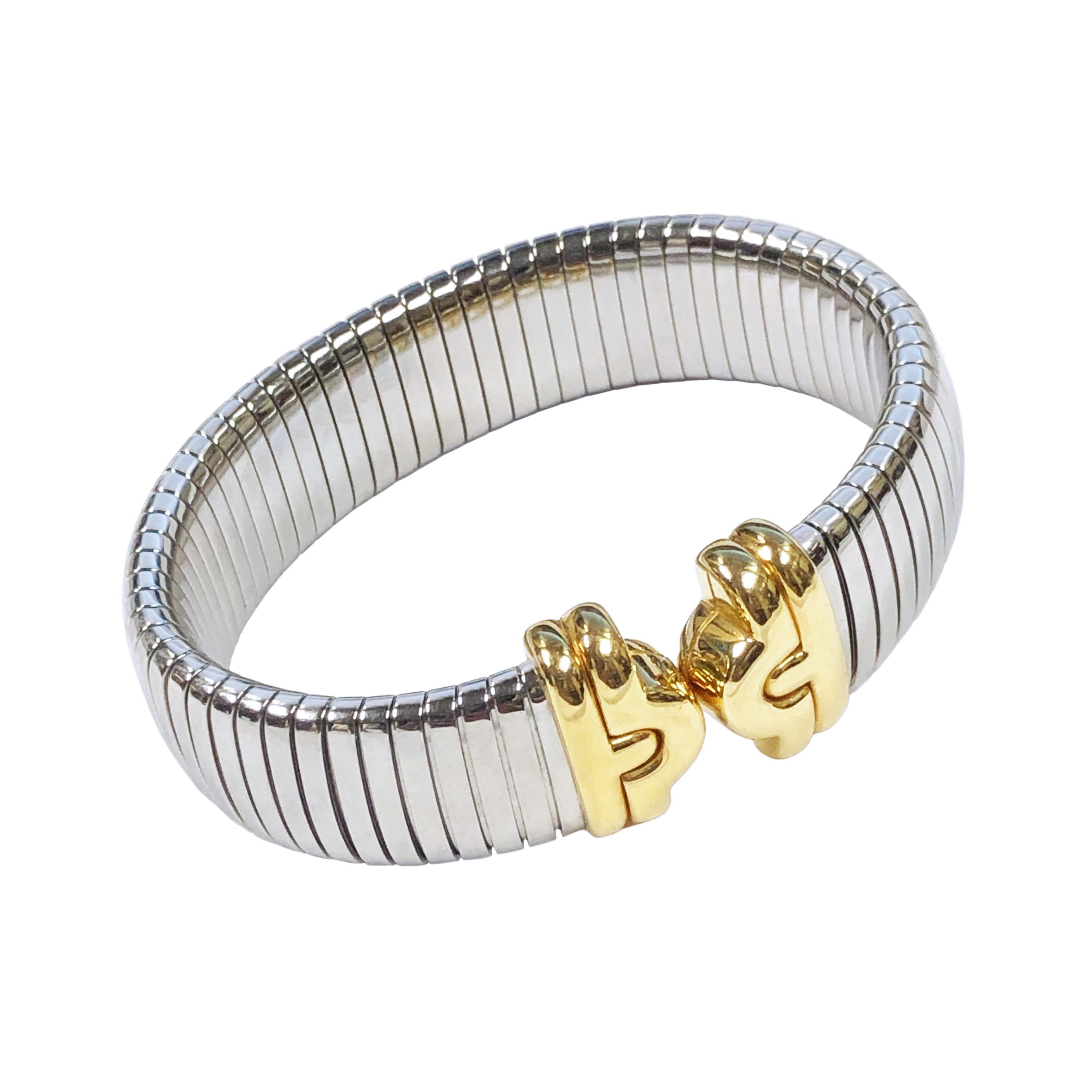 Circa 2010 Bulgari Tubogas collection Steel and 18K yellow Gold Cuff Bracelet, high polished flexible steel measuring 5/8 inch wide and 3/16 inch thick. 6 inches inside measurement and will flex to fit up to a 7 inch wrist.  