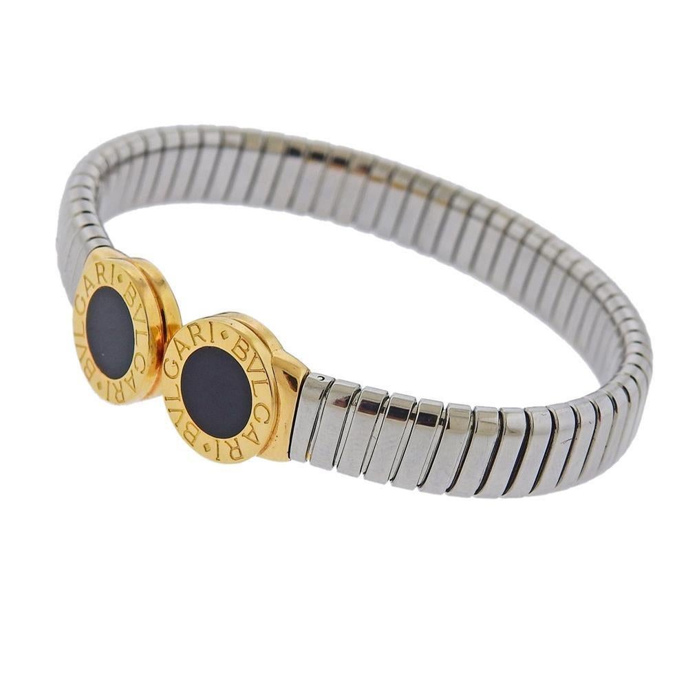 Classic Tubogas 18k gold and stainless steel cuff bracelet by Bvlgari, set with onyx. Bracelet will fit approx. 7