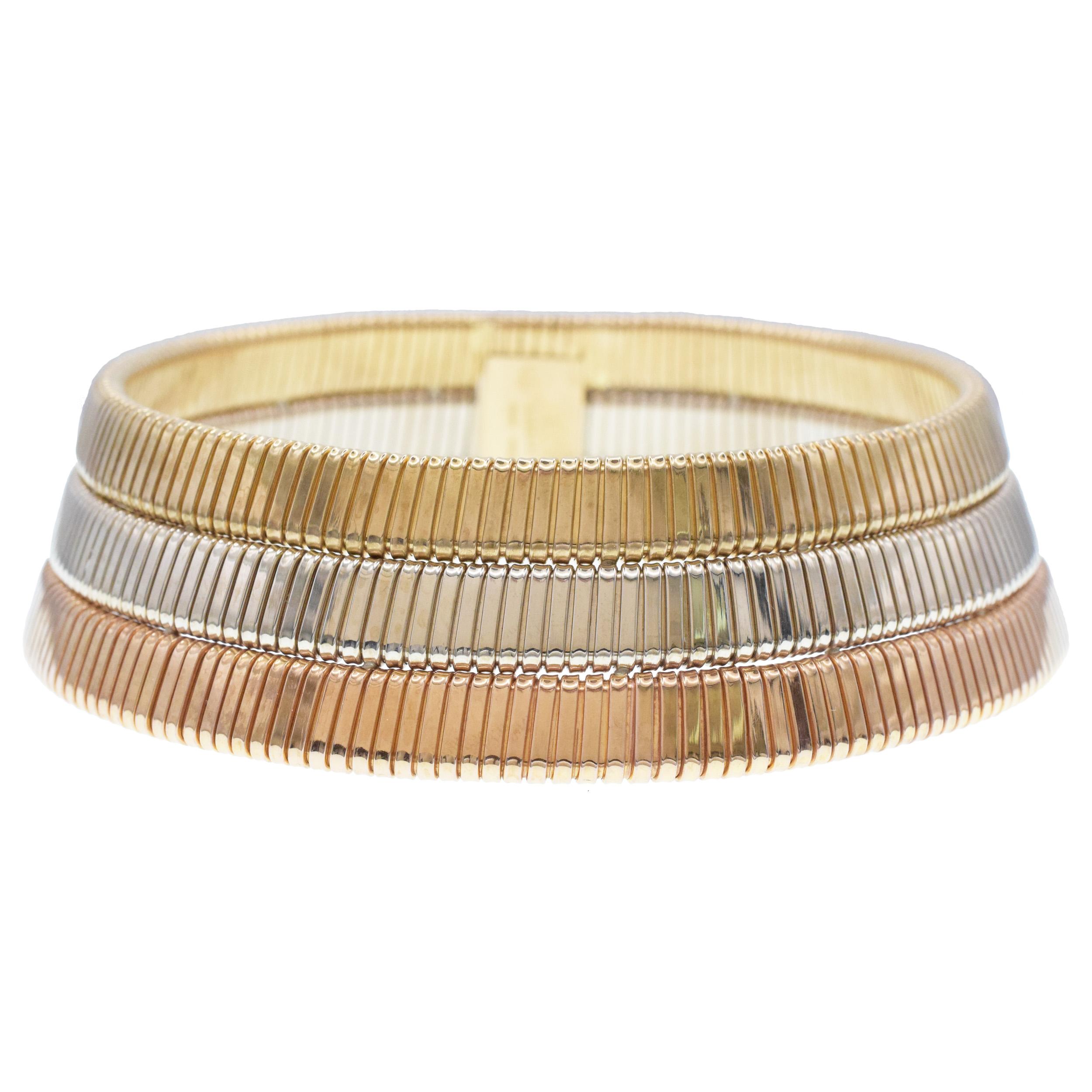 Bulgari Tubogas three row 18k tri-tone gold choker necklace. Circa 1980's. The necklace consists of
18k rose gold band, 18k white gold band, and 18k yellow gold bands connected together. Equipped
with large box clasp. Inscribed: Bvlgari, Made Italy.