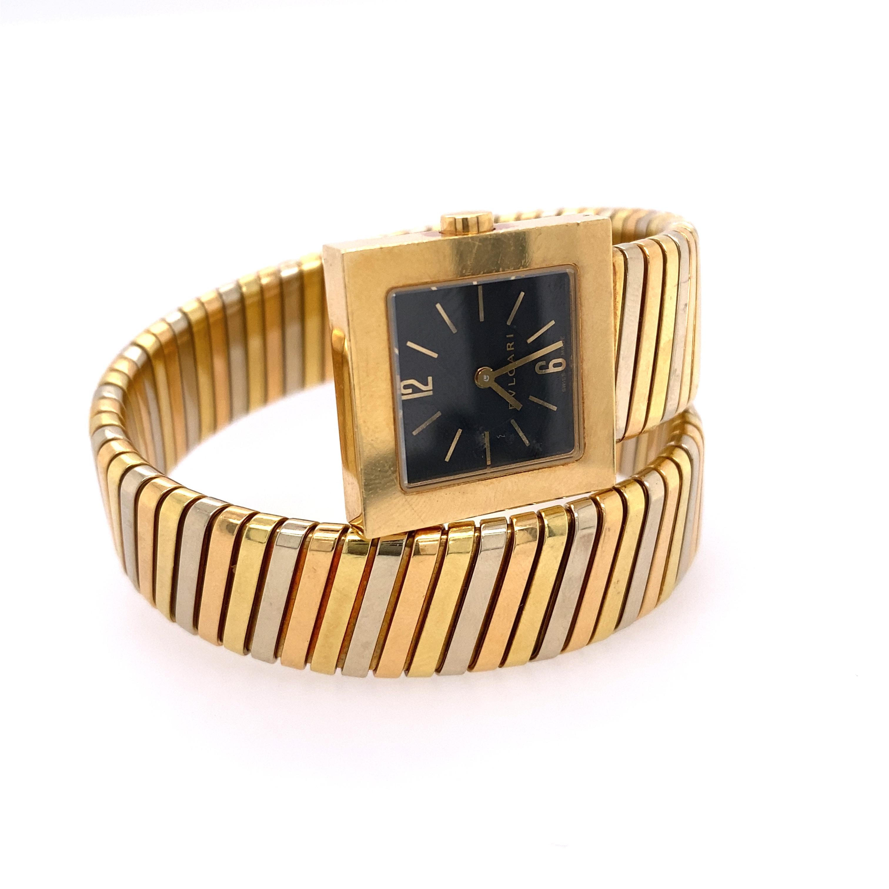 Classic 18k tri color gold wrap Tubogas bracelet watch by Bvlgari, with black dial and quartz movement. Bracelet will fit approx. 6.5-7 inches medium size average wrist.  Case measures 22 mm x 22mm. Ref. SQ 22 1T. Weight  75.3 dwt. 

