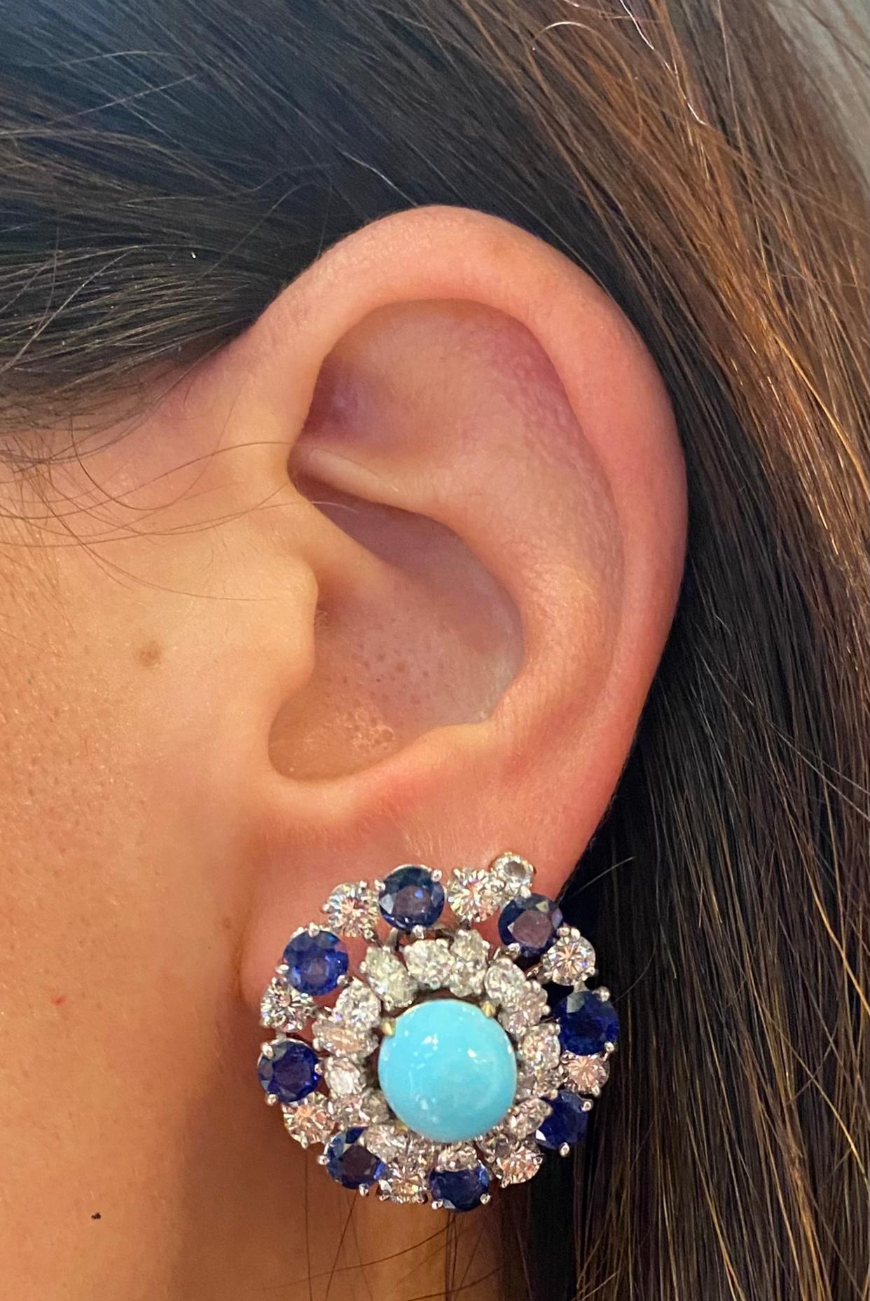 Bulgari Turquoise Sapphire and Diamond Earrings

Pair of Bulgari earrings featuring a center cabochon turquoise surrounded by sapphires and diamonds. 

Approximate Diameter: 1