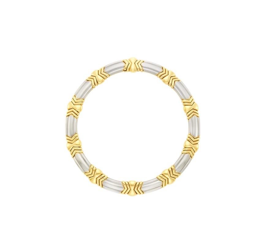 A two colour 18k gold designed by Bulgari, showcasing white gold panels joined by gold panels geometric motif, signed Bulgari, ap. 124.5 dwts. 

Length 16 inches. 
Width of white gold links 1/2 inch. 
Width of gold links 5/8 inch. 