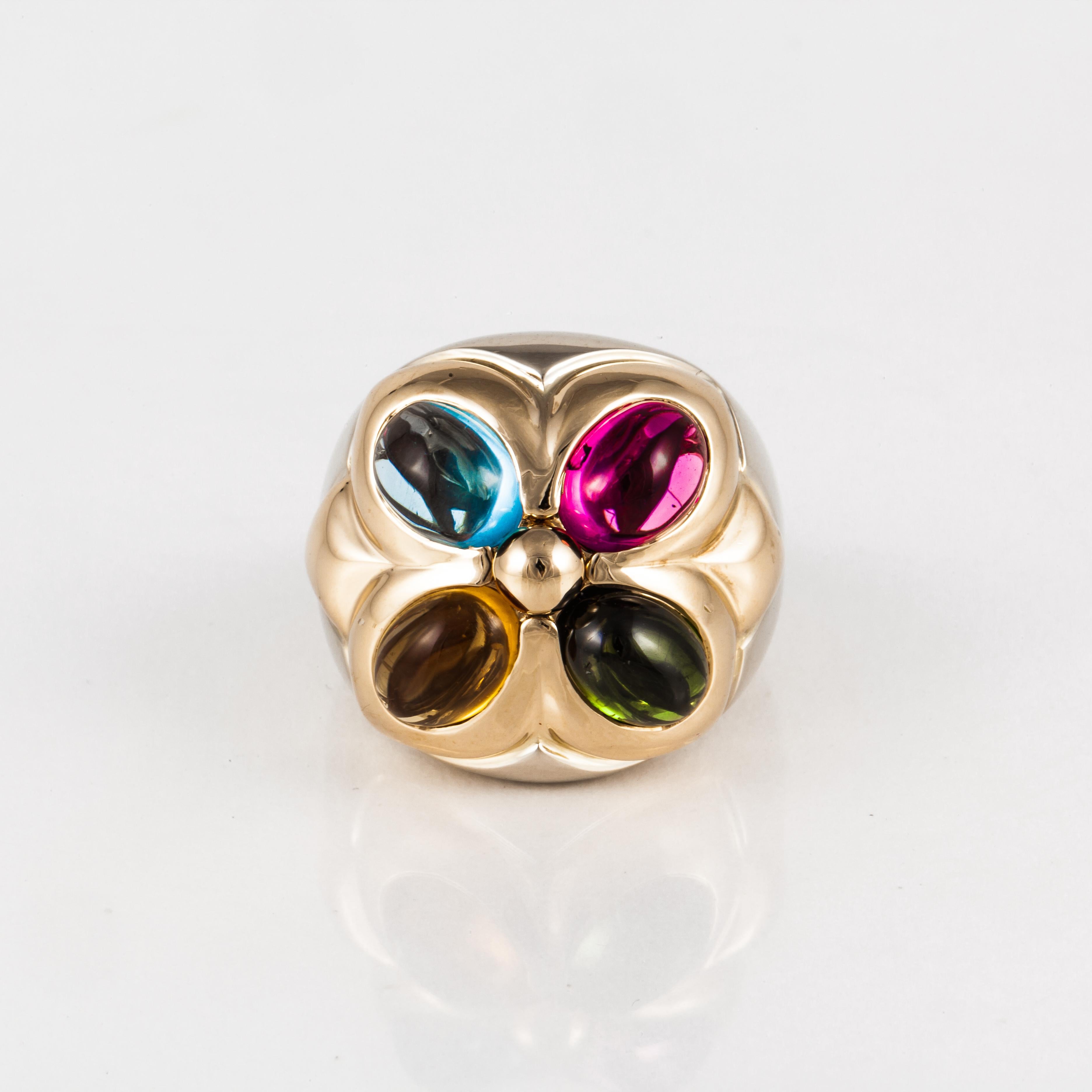 Bulgari ring featuring four oval cabochons in citrine, blue topaz, green tourmaline and pink tourmaline set in 18K yellow and white gold. Ring is currently a size 6 or European 52.  Measures 3/4 inches by 3/4 inches.  