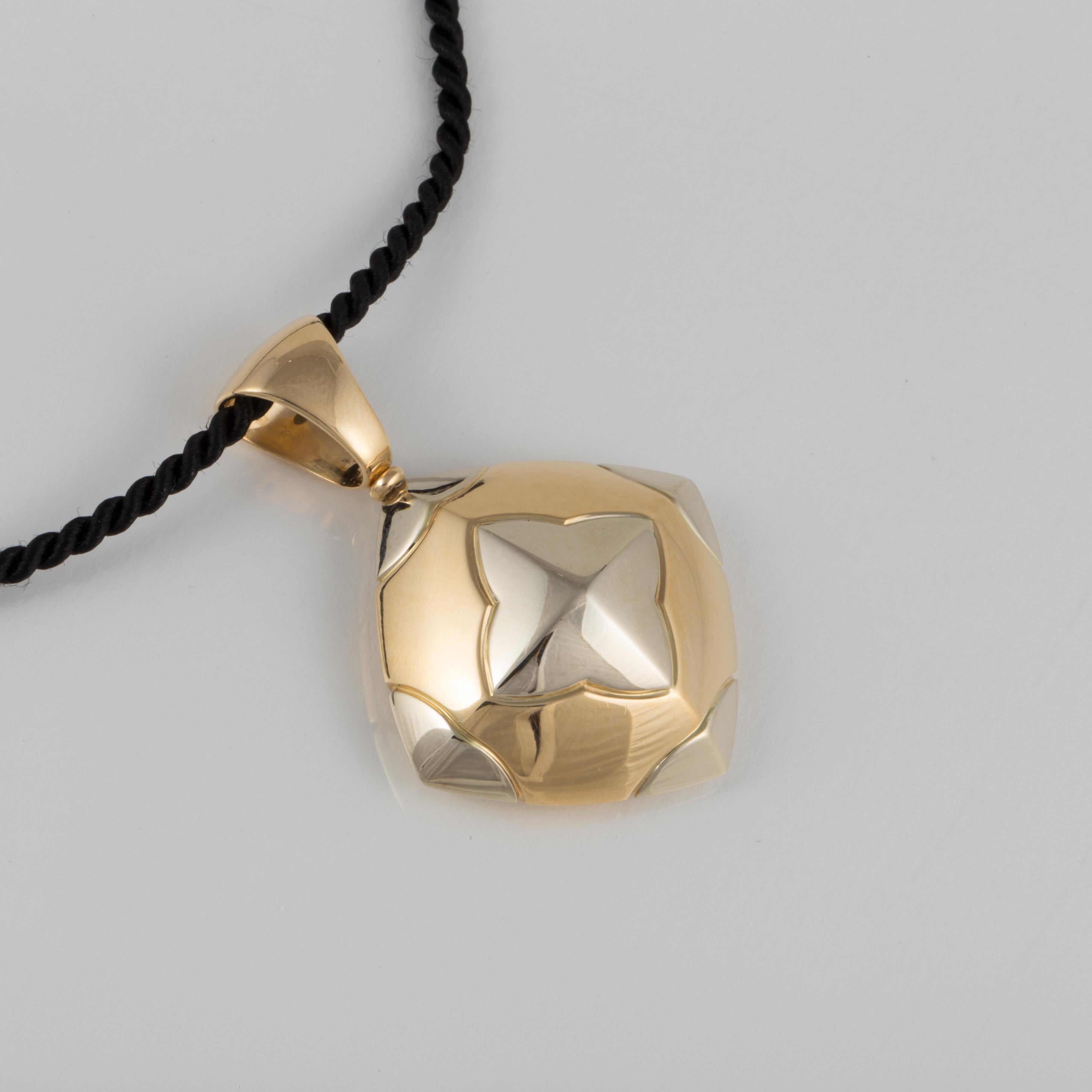 Bulgari Pyramide pendant in 18K yellow and white gold.  Pendant measures 1 5/8 inches long and 1 1/4 inches wide (including the bale).  The cord measures 15 1/2 long, and while included, is not Bulgari.