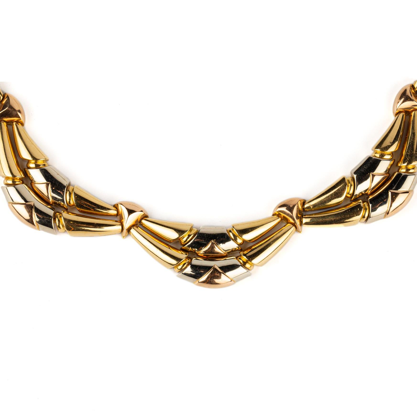 An unusual and articulated necklace in three color 18k gold manufactured by Bulgari. Made in Italy, circa 1980. 