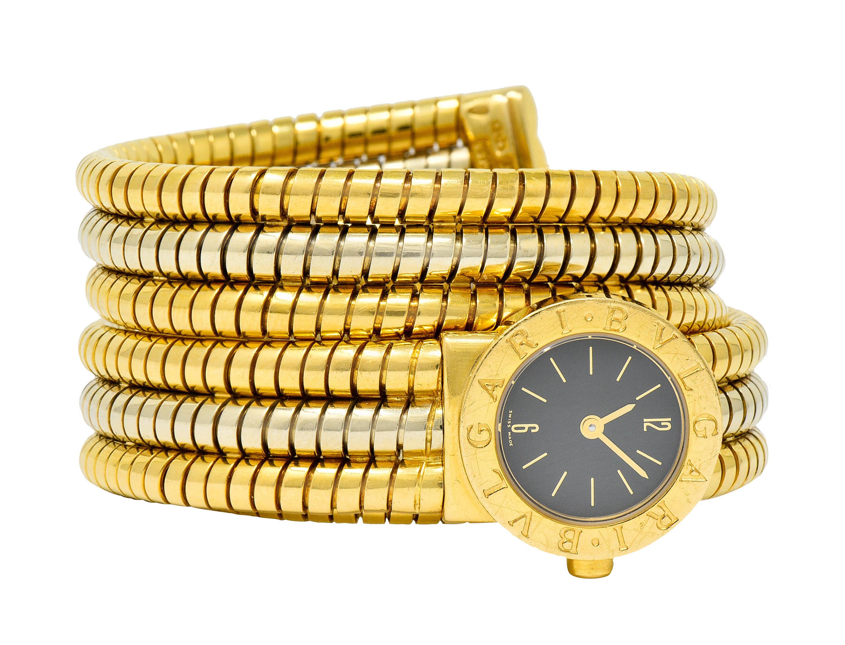 Watch is designed with a coiled tubogas watchband that adjusts to fit most wrists

Comprised of three segments of deeply ridged white and yellow gold

And features a round watch face with gold numerals and dial

Covered by sapphire crystal with a