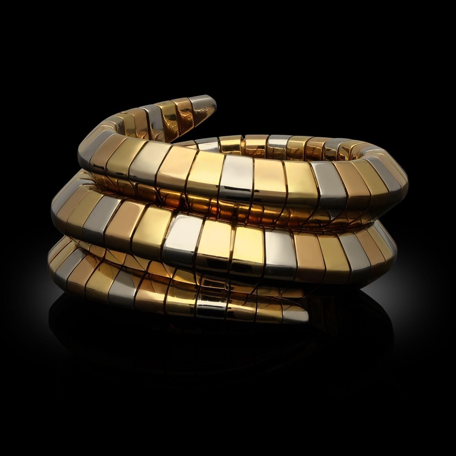 A vintage tricolour gold Serpenti Tubogas cuff bracelet by Bulgari, 1990s. The cuff bracelet is crafted in three colours of 18ct gold, a highly flexible Tubogas design that wraps around the wrist and has a softly domed pyramidal profile. Each end
