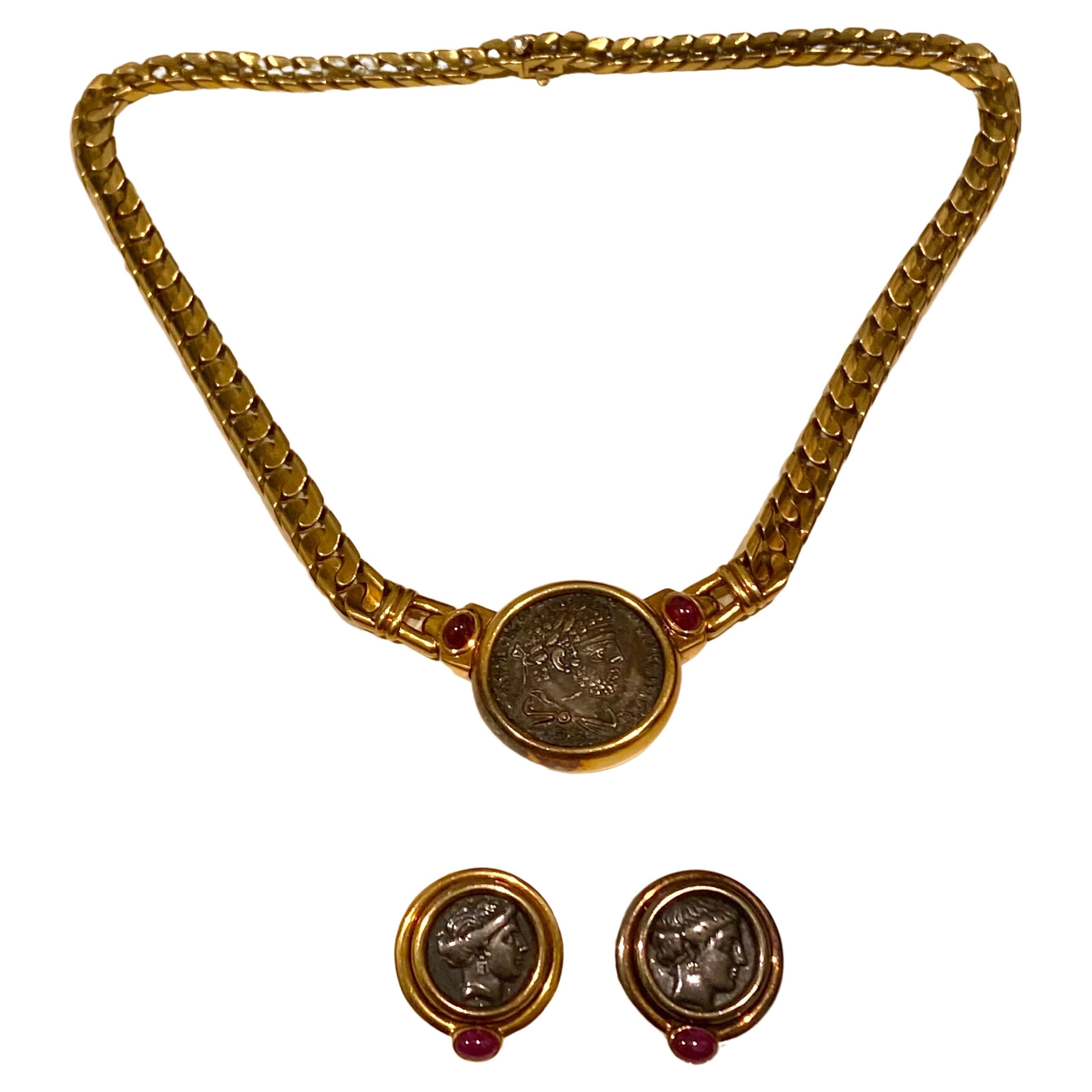 This vintage Bvlgari piece is designed as a curb link chain in 18k yellow gold with gold-framed of the ancient bronze coin as a pendant.  Bezel set with two round cabochon genuine rubies weighing approx. 3.00 carats in total and one round diamond