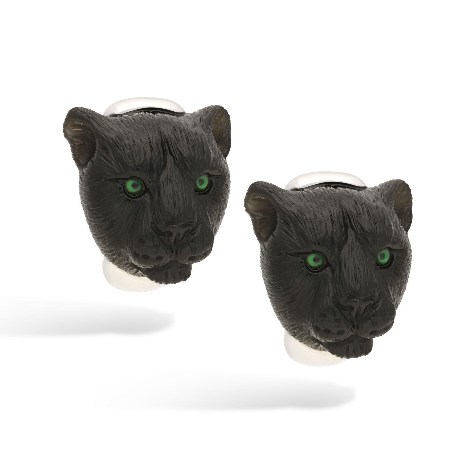 A vintage pair of black panther earrings by Bulgari, circa 1970. Each earring is a piece of black onyx carved to depict the head of a panther, with eyes painted vibrant green and set behind rock crystal. The earrings are mounted in 18ct white gold