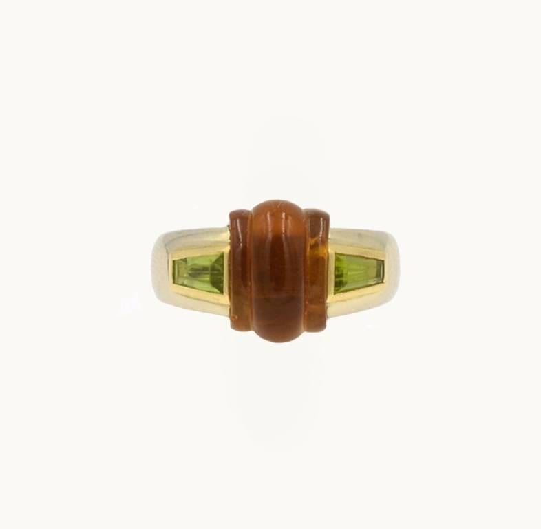  Bulgari vintage ring in 18 karat yellow gold from circa 1980s.  This fantastic ring features a center piece of carved citrine flanked by two trapezoid peridots.

Currently a US size 5.5 and easily adjustable.

This ring measures approximately 0.31