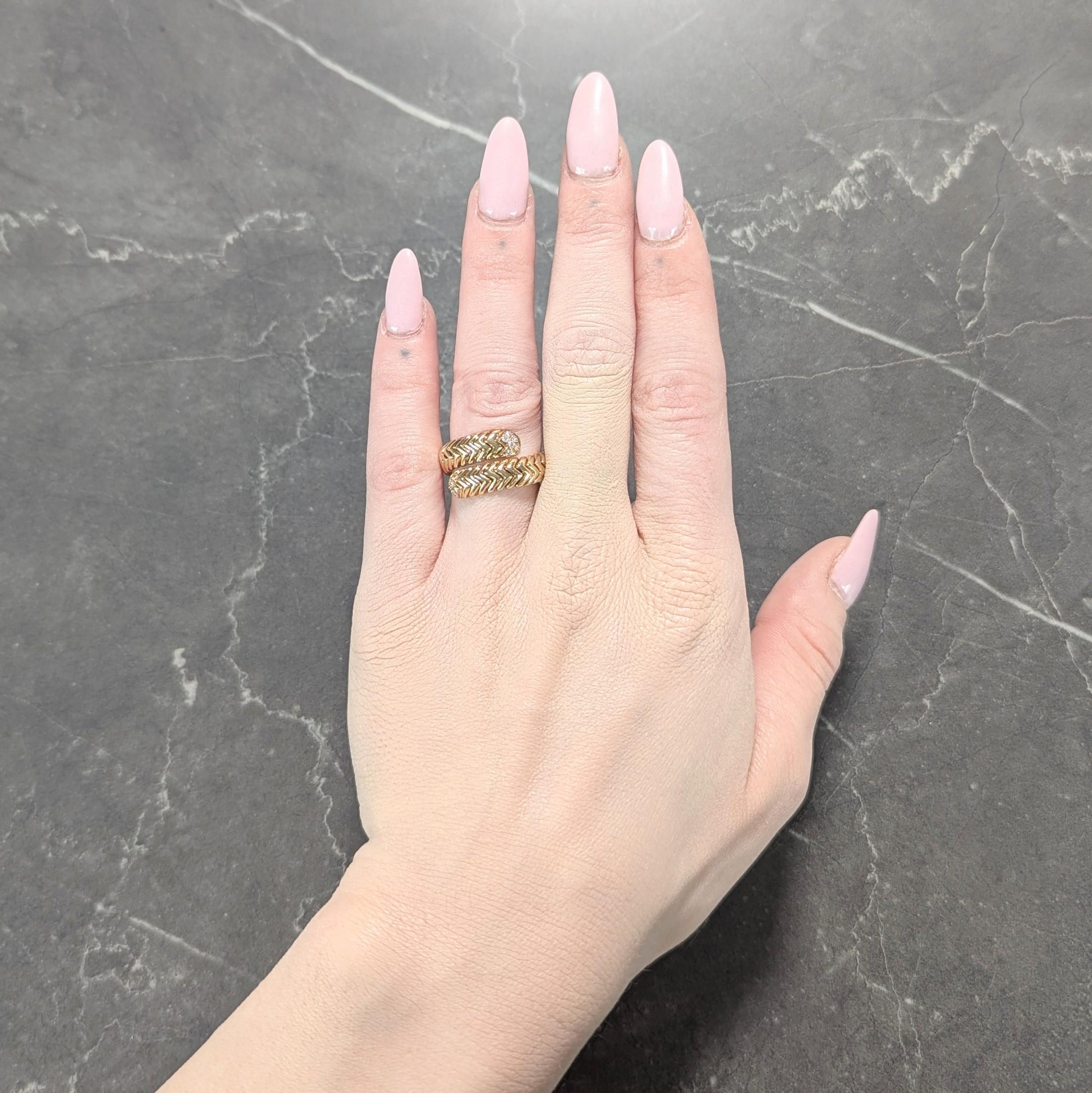 Designed as a bypass style ring comprised of segmented chevron motif 'Spiga' tubogas
With considerable flex and terminating with bead set round brilliant cut diamonds
Diamonds weighs approximately 0.18 carat total - G/H color with VS2
